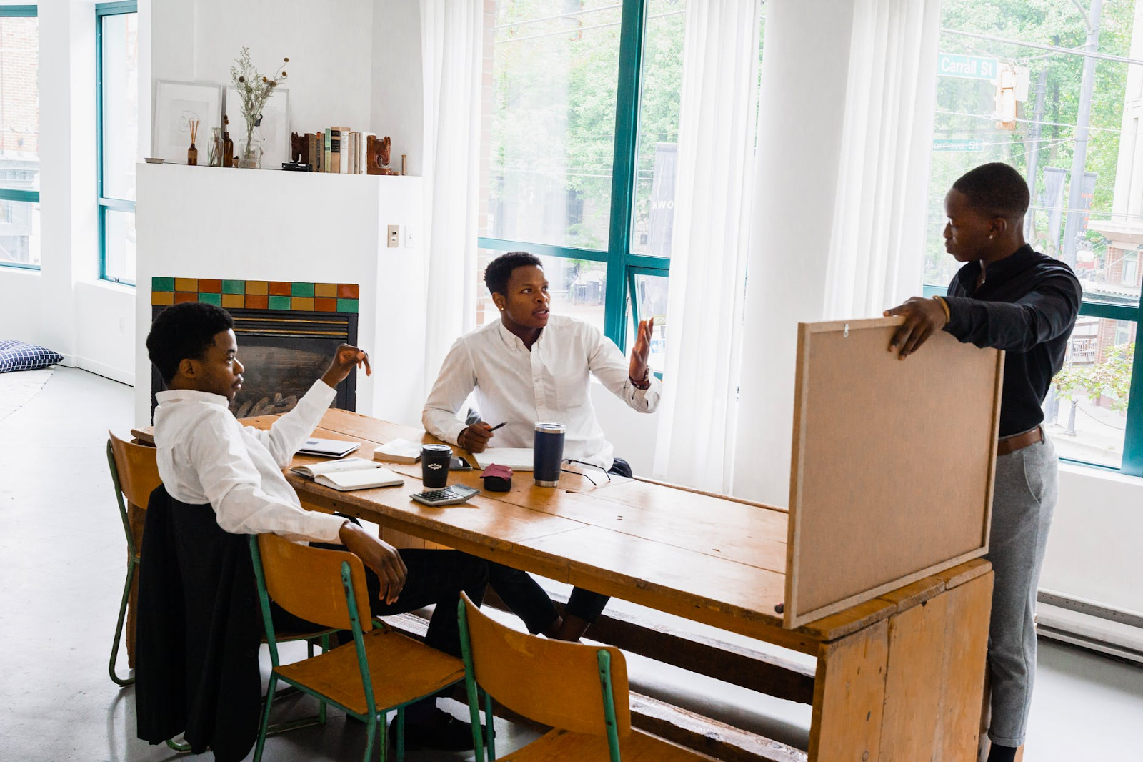 Three men discussing business strategy.