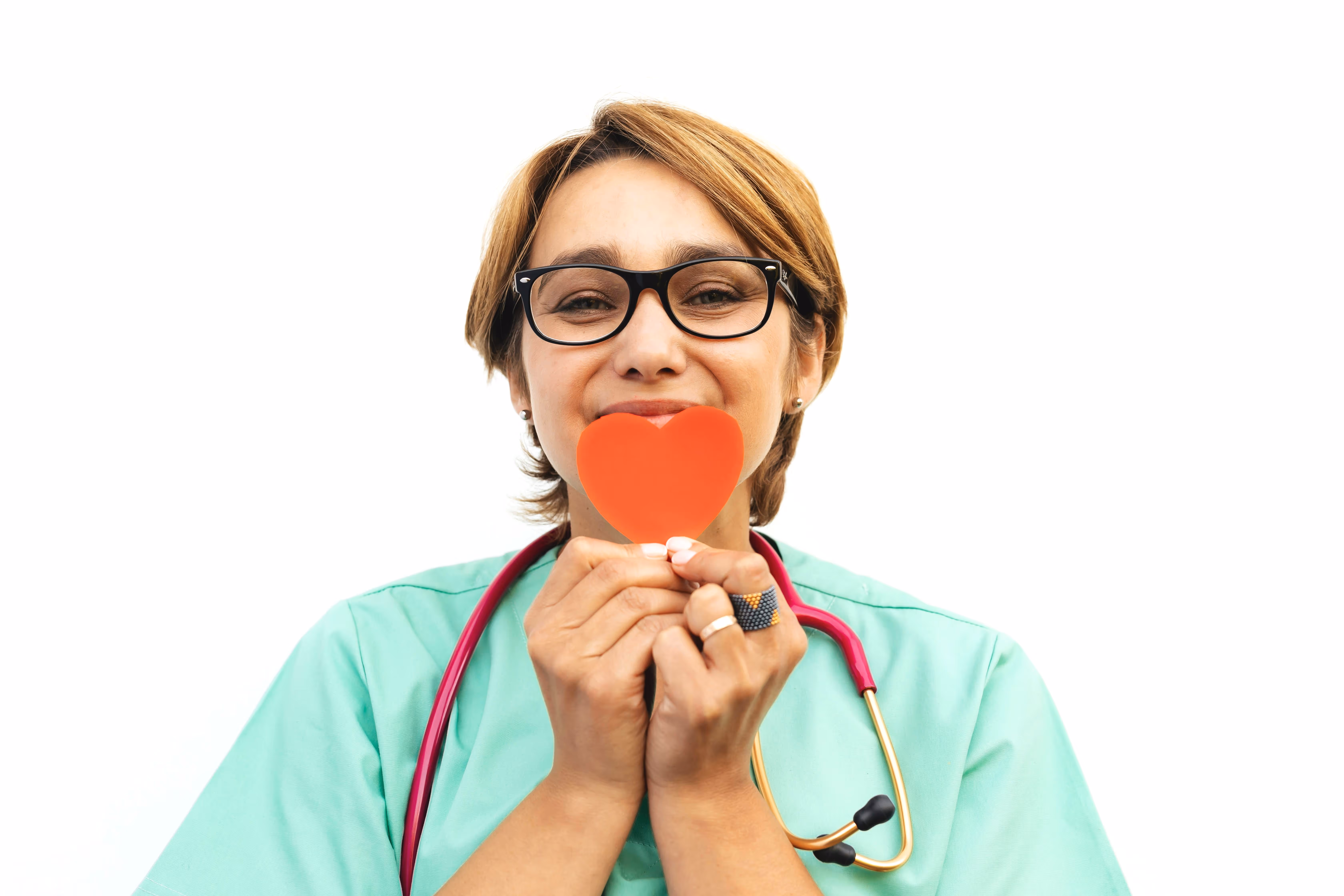 Medical assistant holding a red paper heart in front of her face