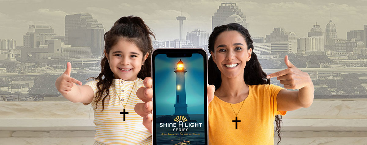 Mother and daughter holding phone with Shine A Light Beacon on screen. Both pointing to the phone.