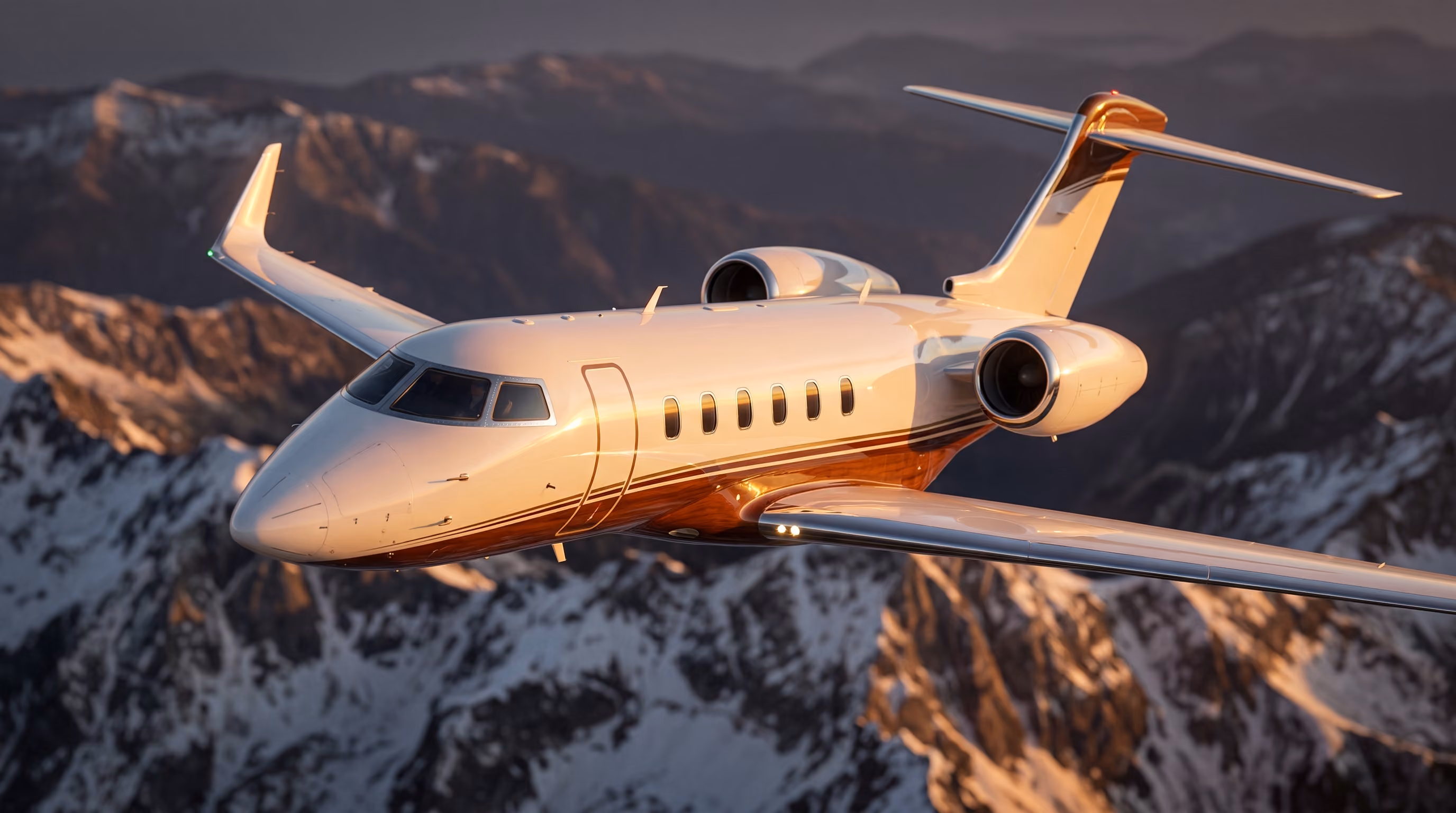 Private jet flying above snow-capped mountains during sunset, with warm light reflecting on the aircraft's body.