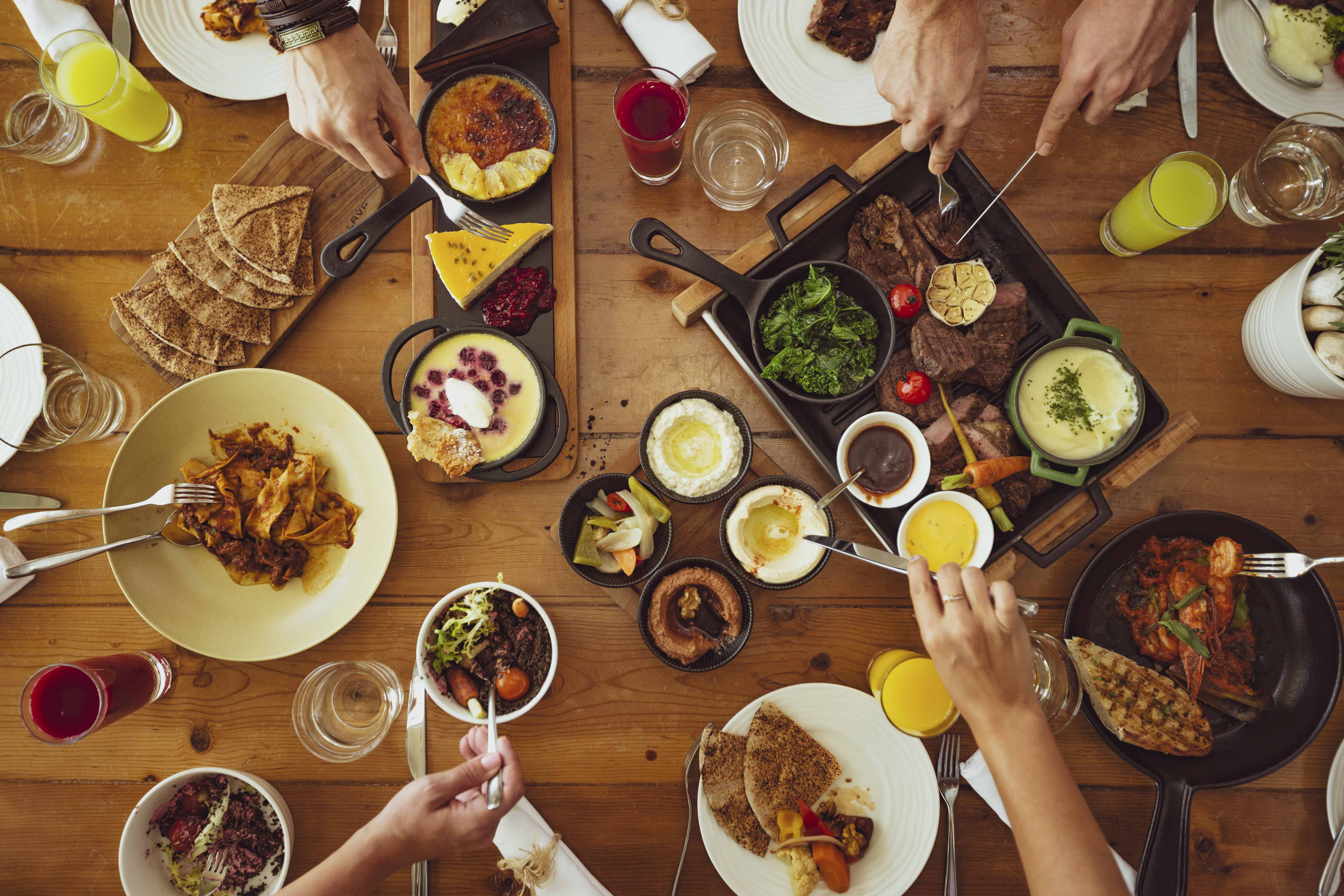 A top down photo of a table with lots of items of food. Image was taken at Café Nikki in Dubai.