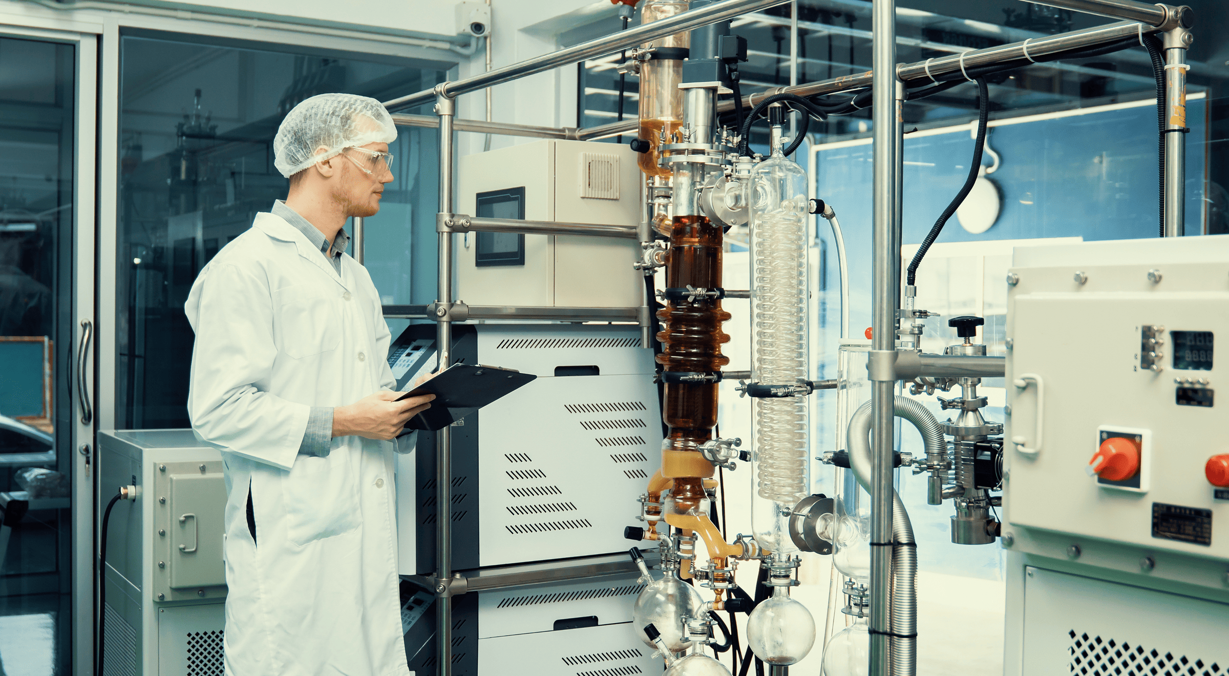 Scientist monitoring a distillation apparatus in a laboratory