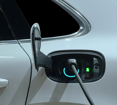 Electric vehicle charging port with connected charging cable