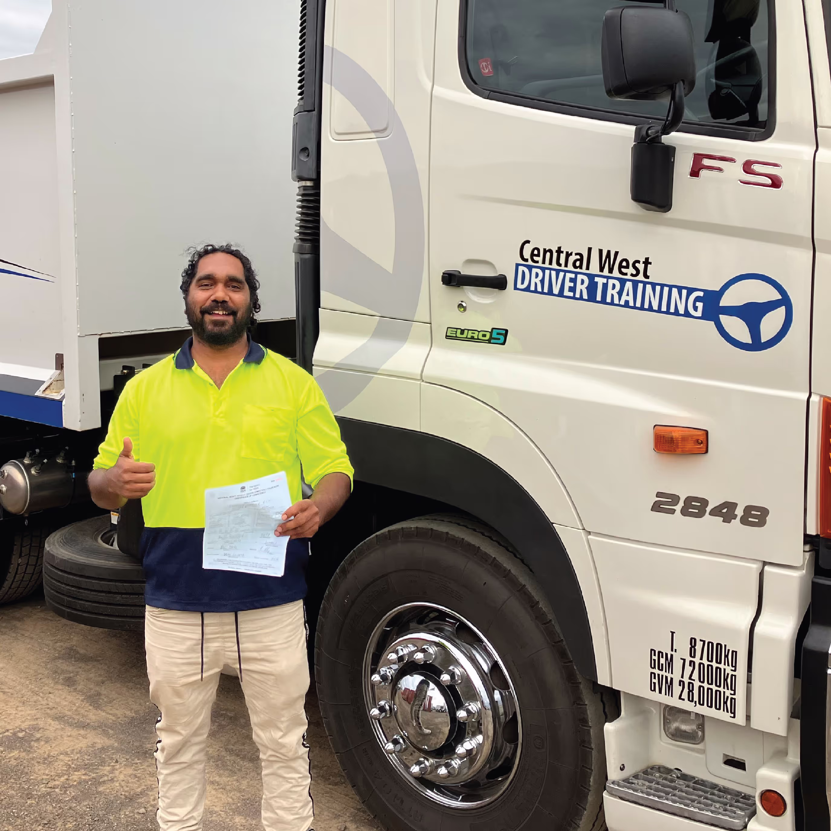 Man standing in front of driver training truck