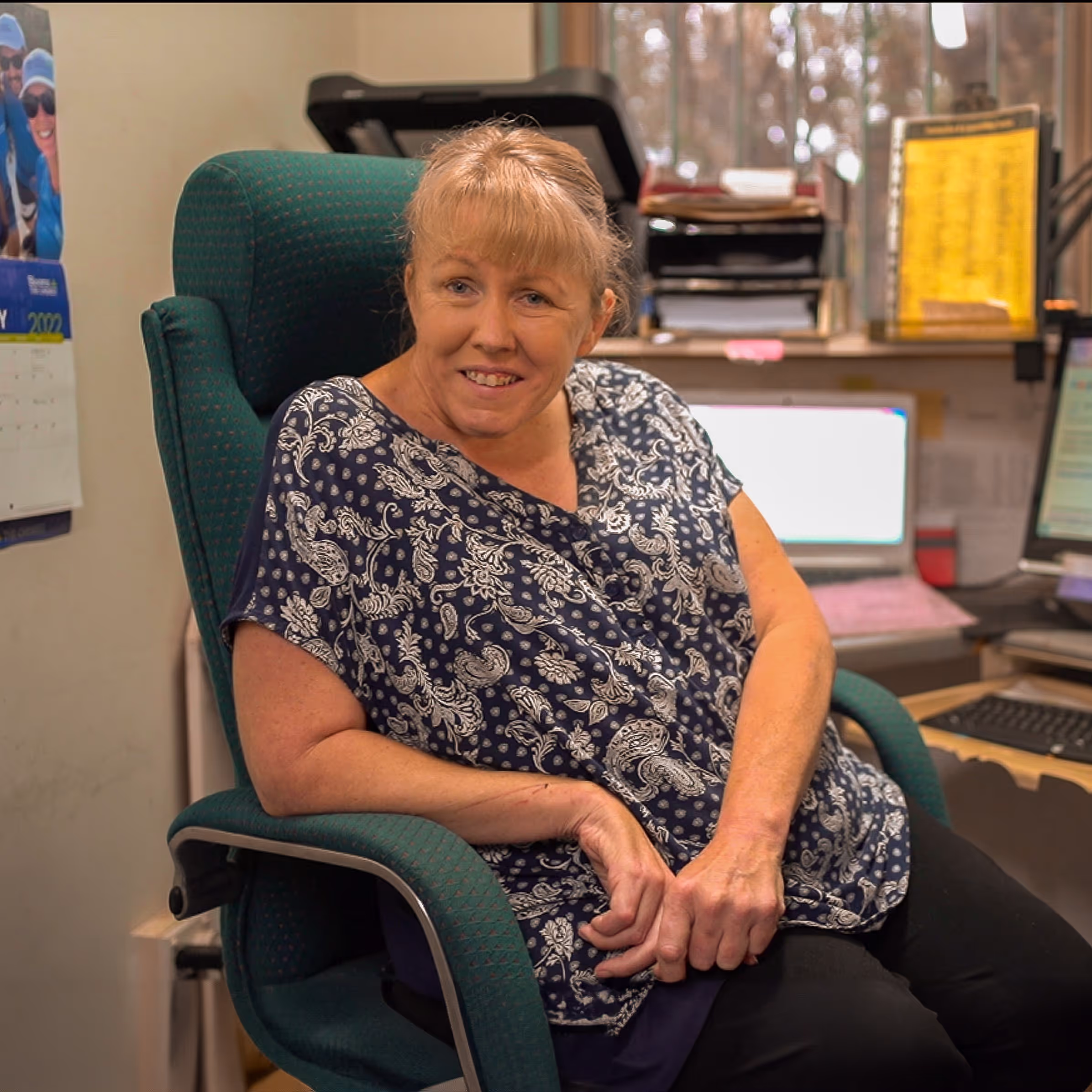 A woman sitting in a green chair