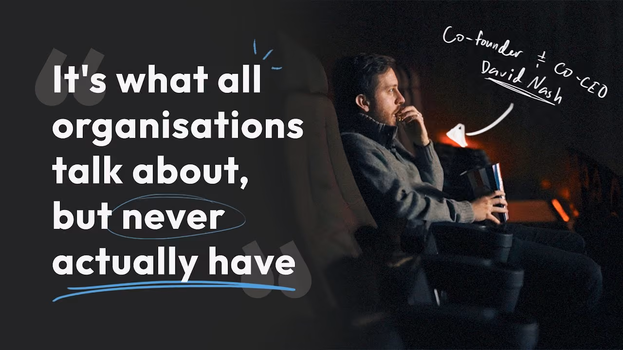 Man sitting in dark room watching screen, text: It's what all organisations talk about, but never actually have.