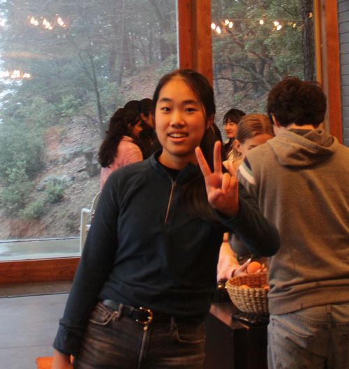 A candid photo of Jacqueline smiling wide in front of her laptop (most likely in response to something funny her friends said)