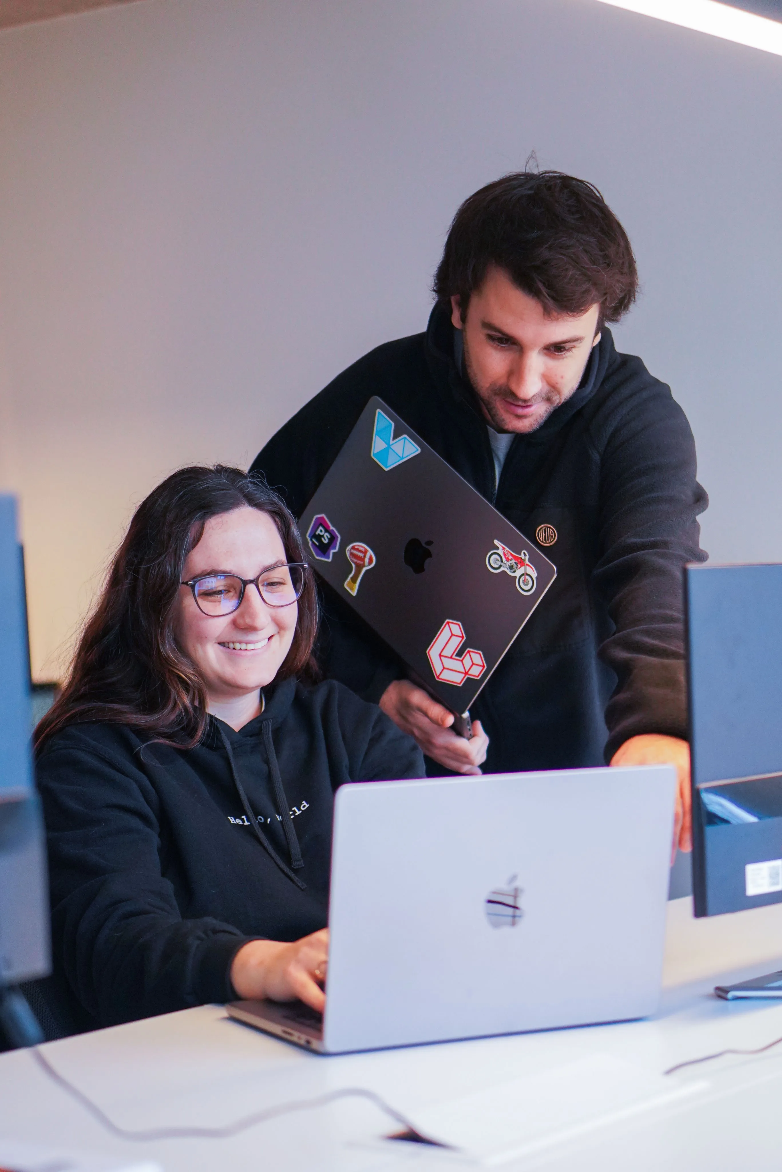 A software developer teaching a trainee to code
