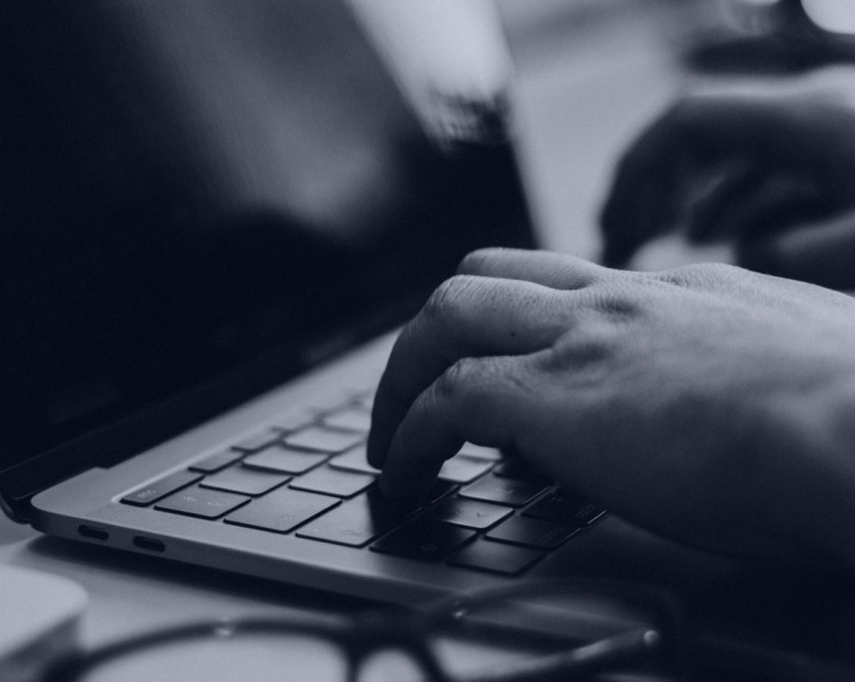 Man typing on a laptop computer
