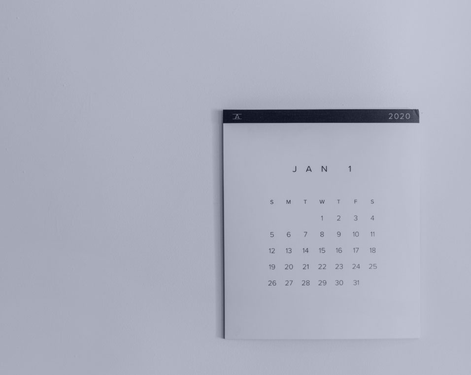 A paper calendar hanged in a wall.