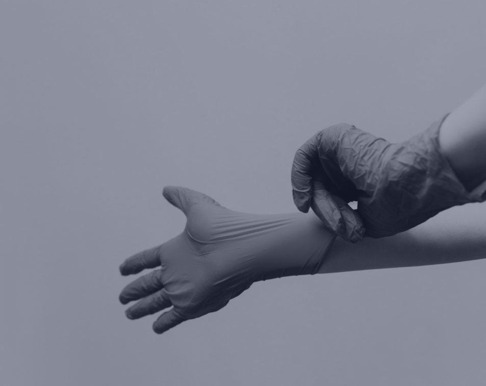 Pair of hands donning medical gloves.