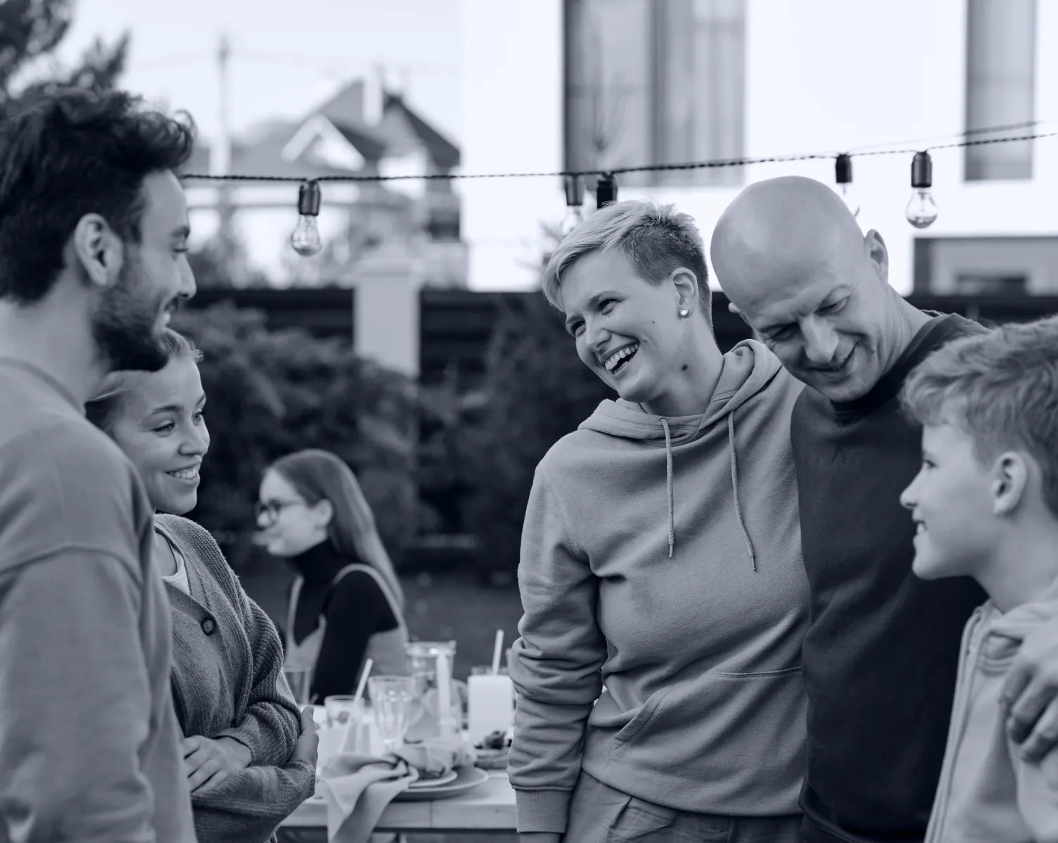 Happy family smiling, hugging outdoors during lunch