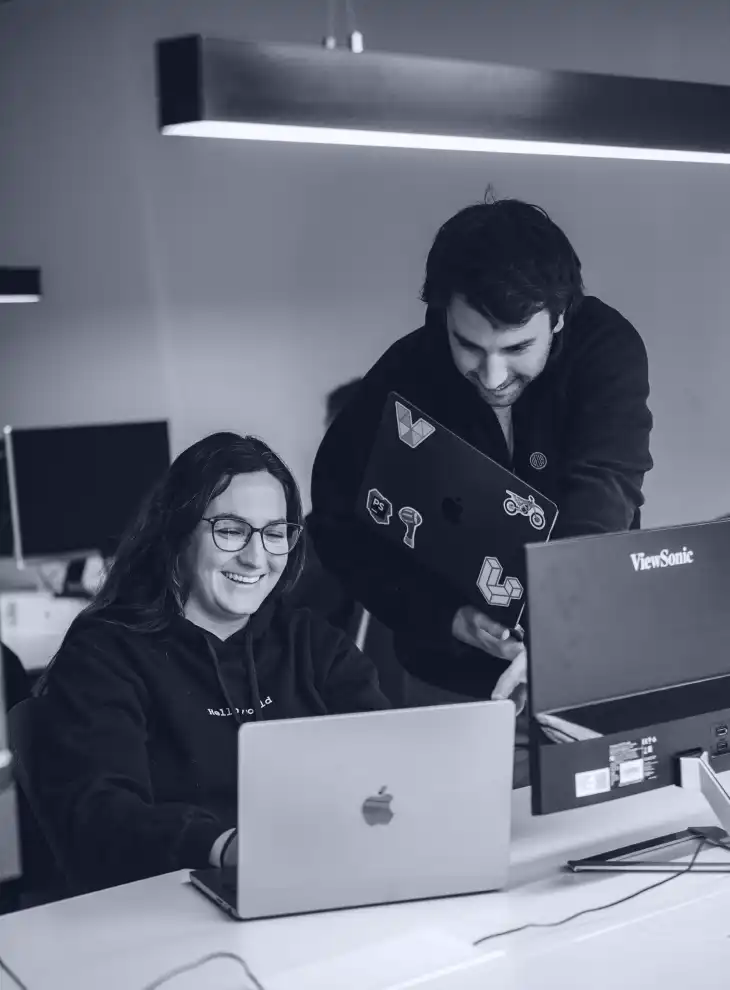 Two project managers and a software developer discussing about a digital health product on their computer