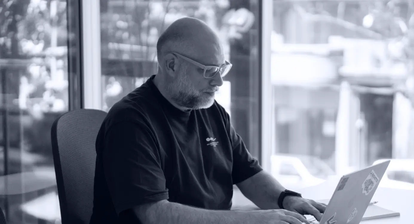 Two project managers and a software developer discussing about a digital health product on their computer