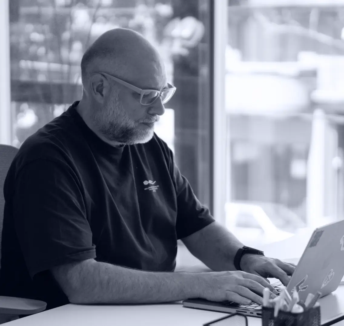 A professional focused on a laptop, representing the strategic decision-making behind EHR migration