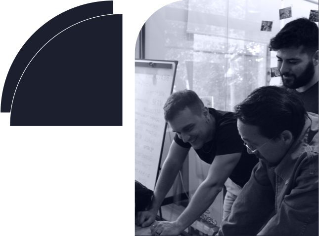 A group of three healthcare web developers brainstorming and a green geometric shape that says your ideal innovation partner