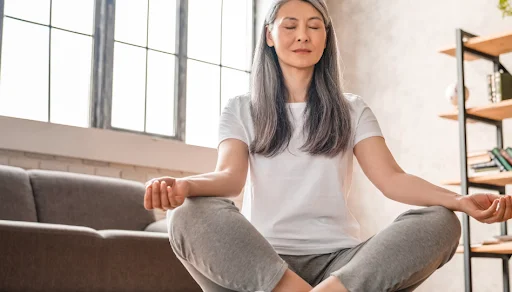 Woman meditating in a bright living room