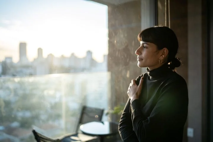 Woman looking out an office window