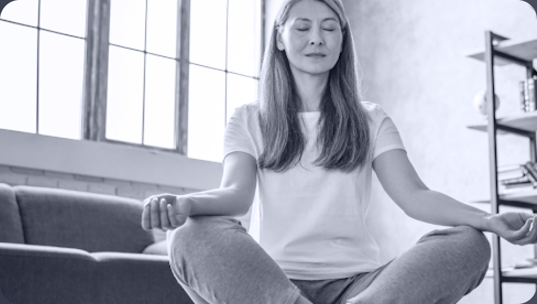 Woman meditating in a bright room