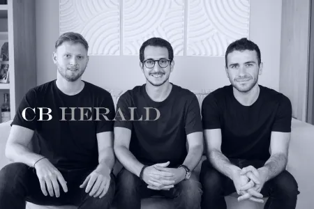 Light-it founders seated on a sofa, with the CB Herald logo