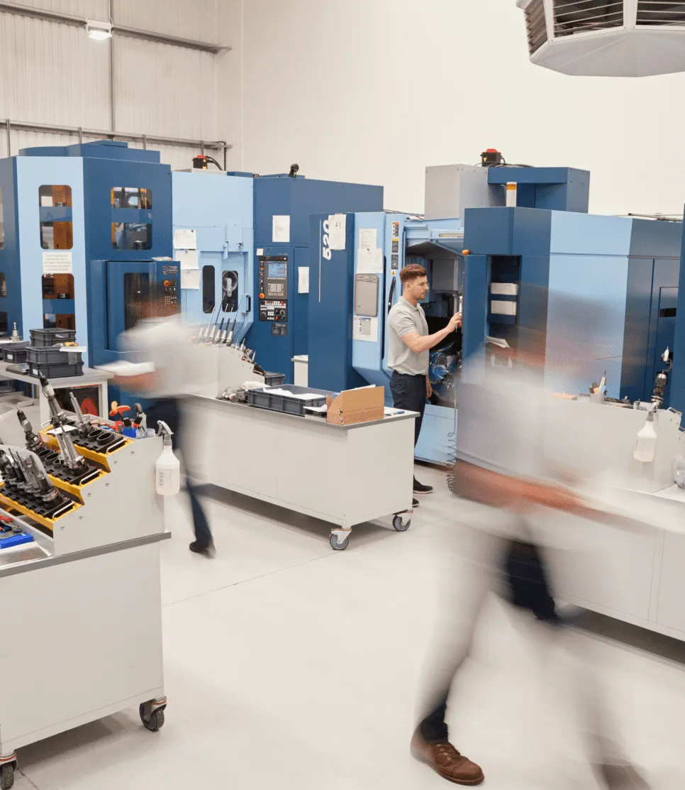 Lab workers move quickly through a facility with bright white light.