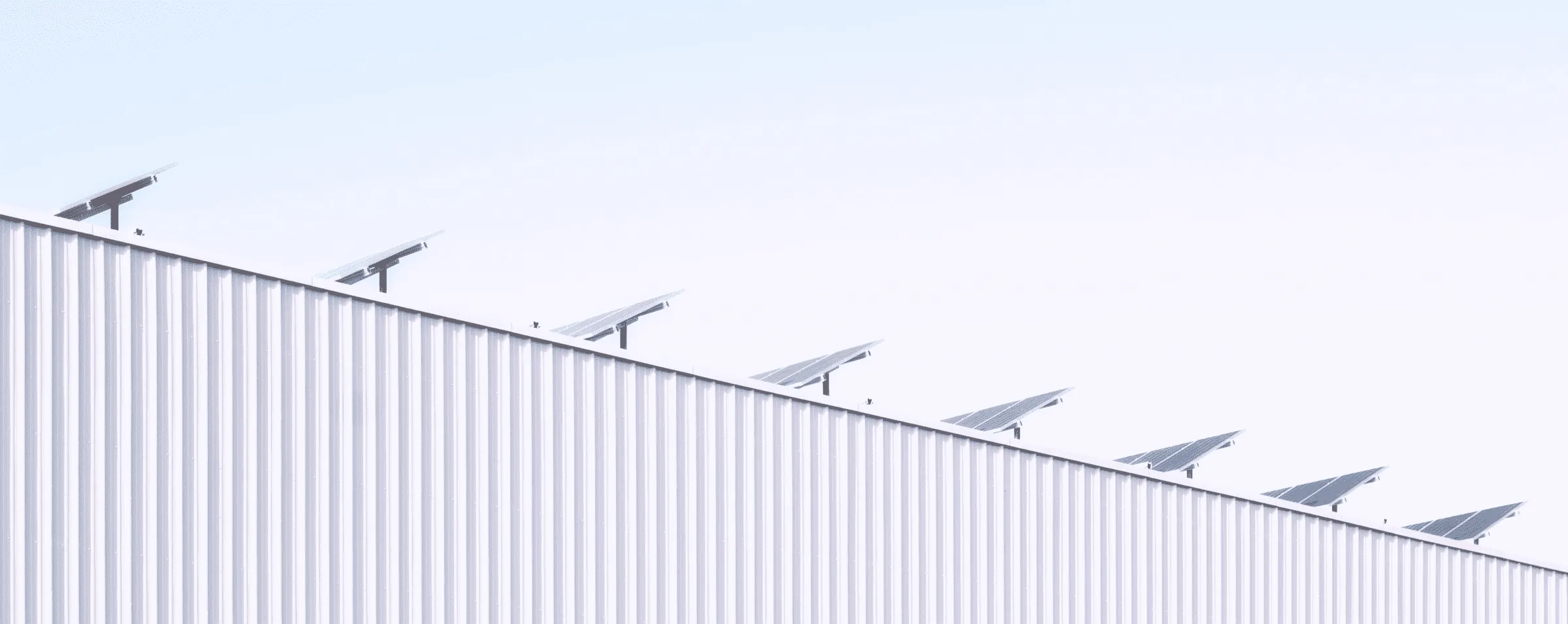 Solar panels sit on top of a roof on a bright day.