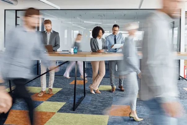 Employees move quickly through an office building.