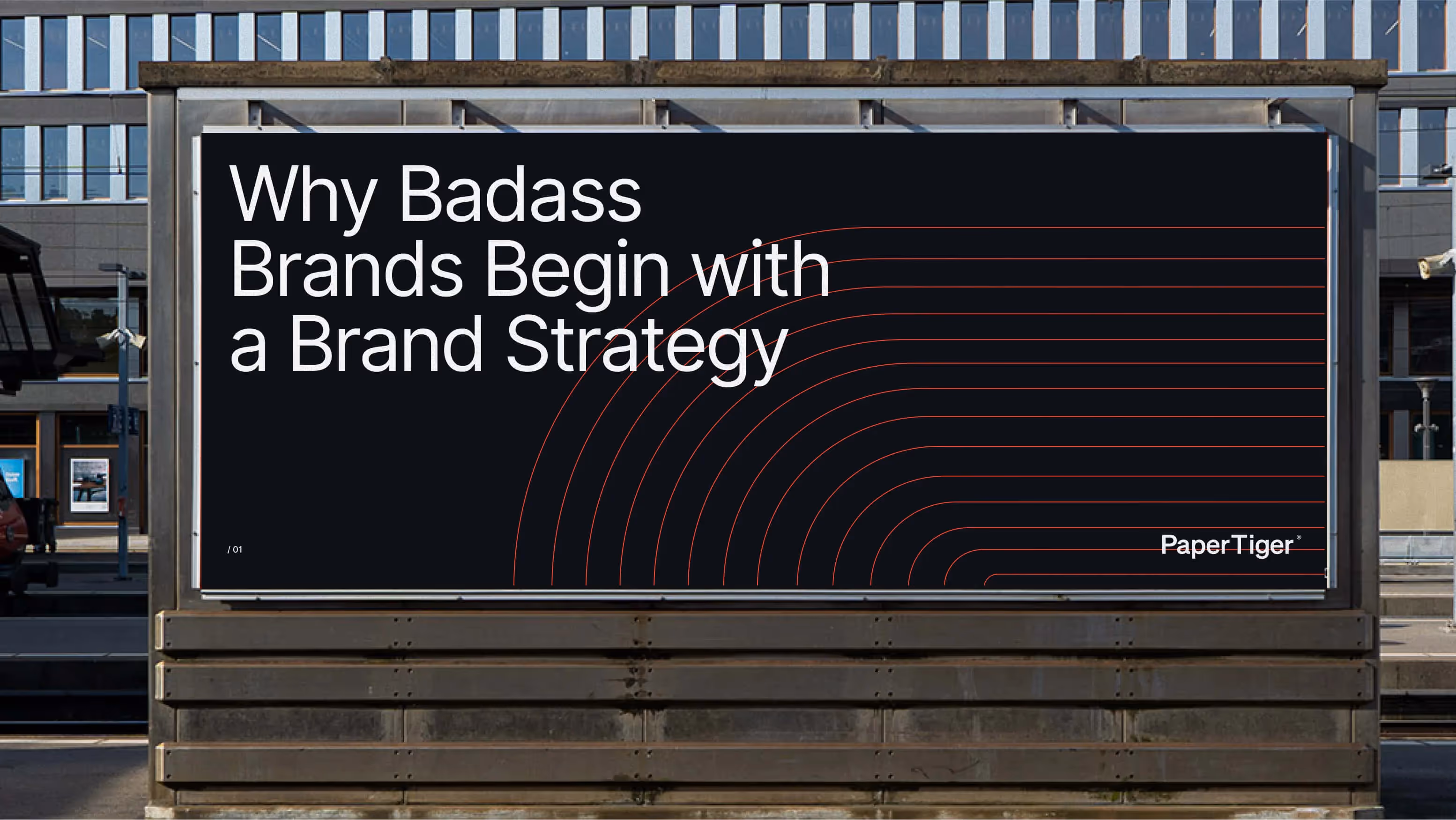 A photo of a large billboard in an urban setting that displays the name of the article on a black background
