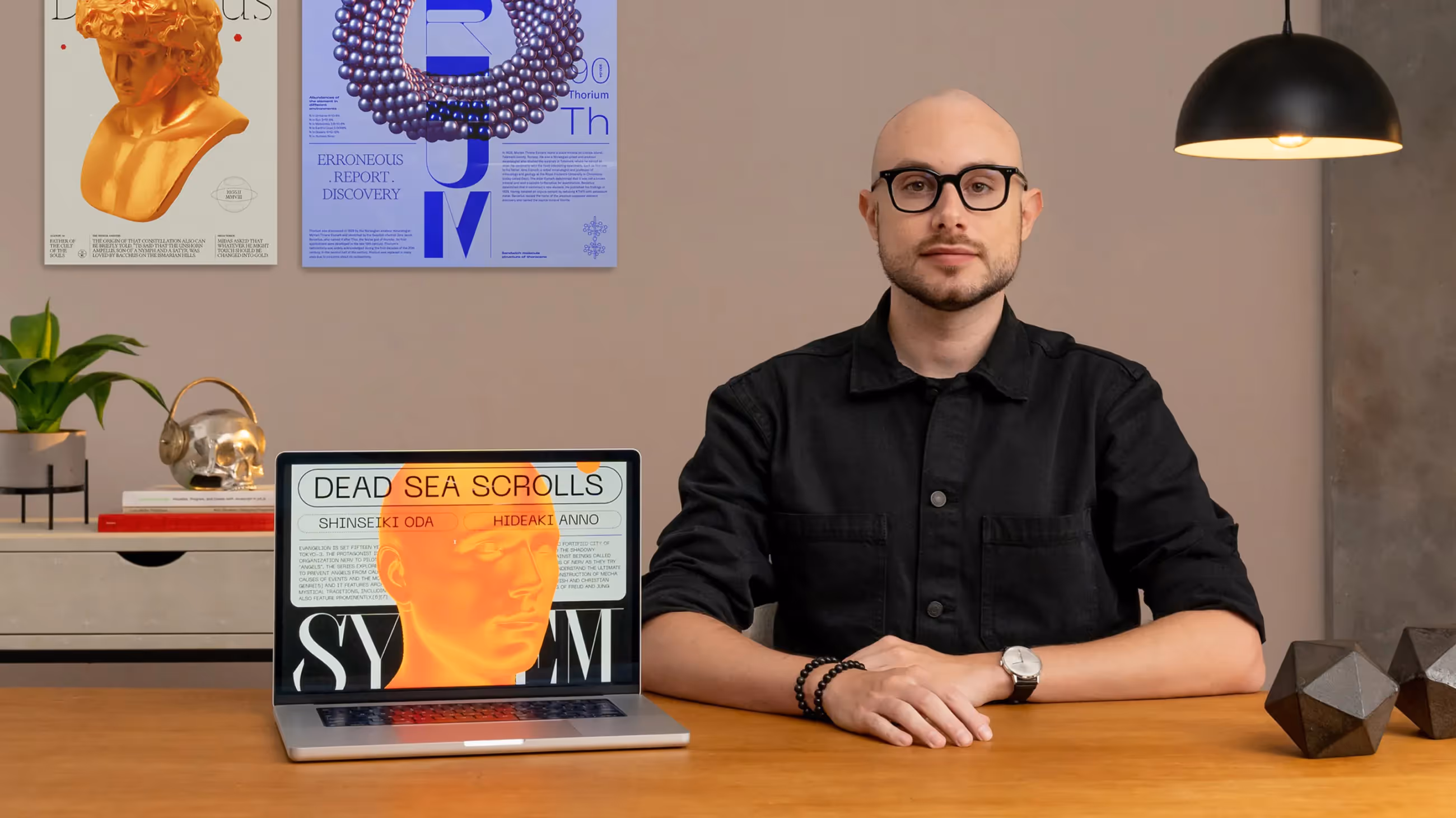 Photo of Mirko Santangelo sitting at a modern desk next to a laptop