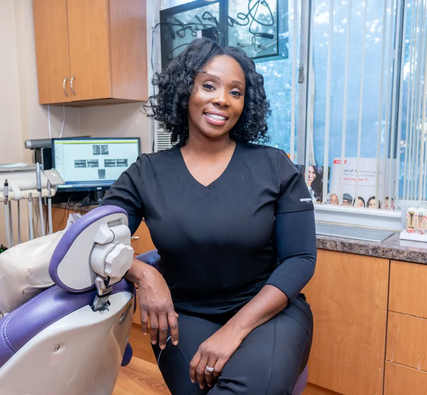 a woman sitting in a dentist chair with a microscope