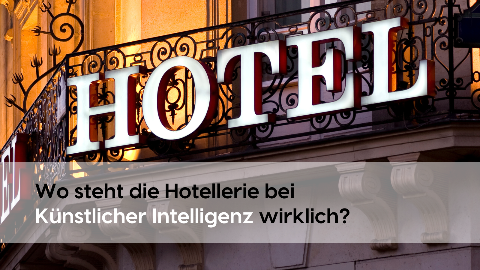 Façade of a classic city hotel with illuminated “HOTEL” lettering on the wrought-iron balcony. This raises the question: “Where does the hotel industry stand when it comes to artificial intelligence?