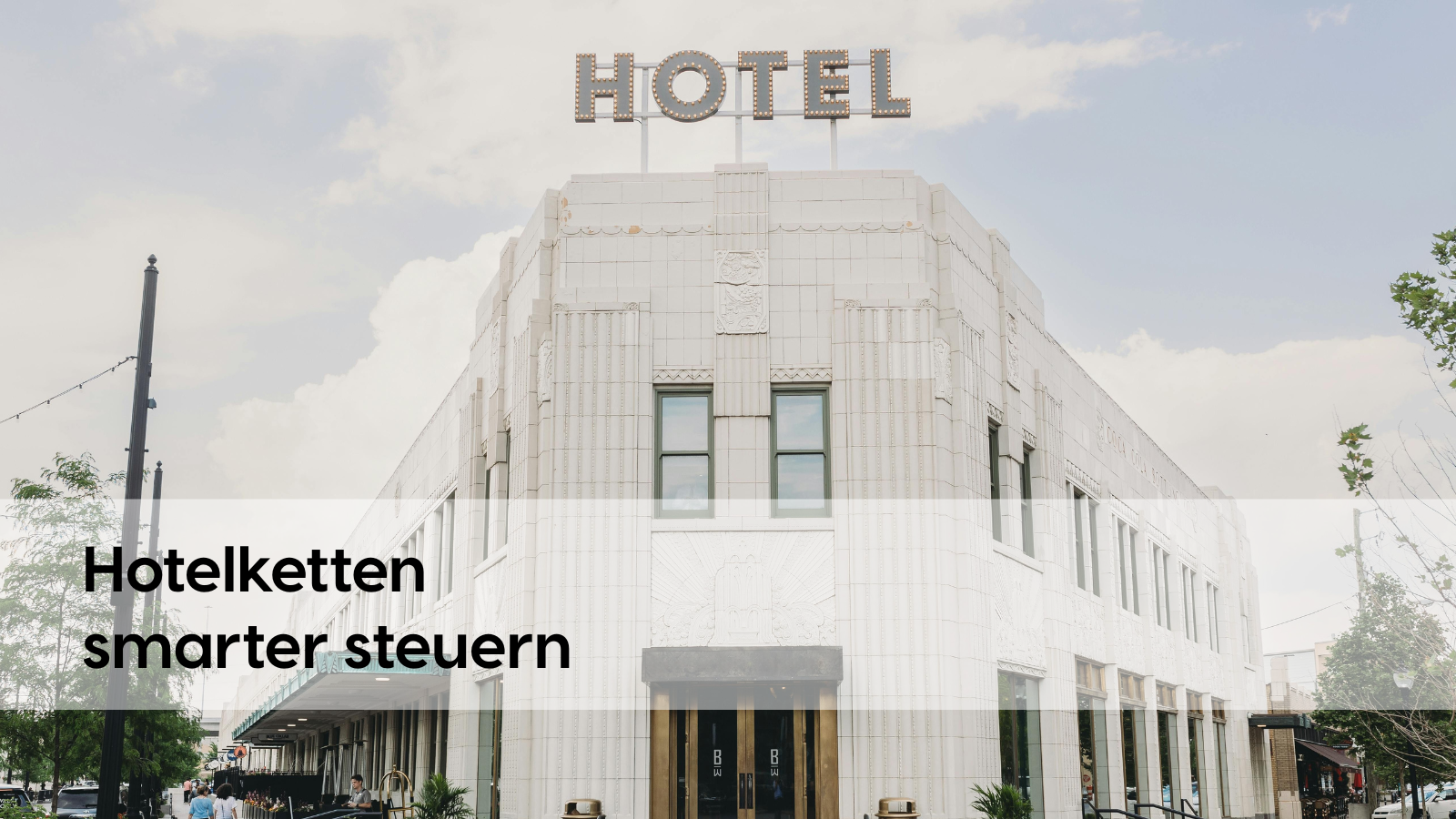 Exterior view of a stylish city hotel with an art deco façade with the word “HOTEL” glowing over it. In the middle of the picture is the slogan “Manage hotel chains smarter”, and at the bottom right is the logo of Profitize. The image highlights modern, digital control solutions for hotel groups.