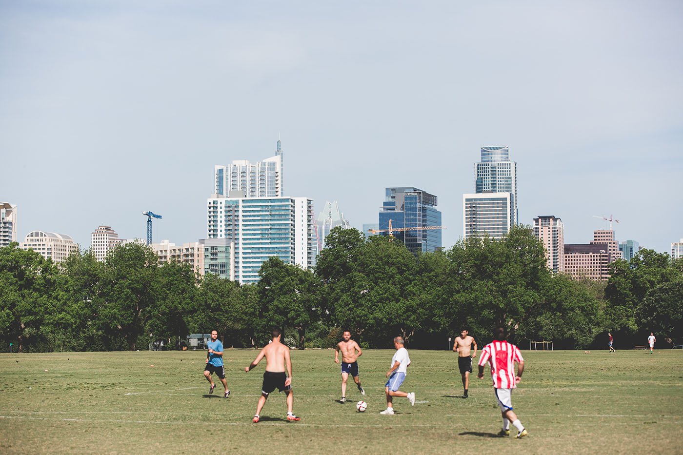 Zilker Park field with the downtown skyline