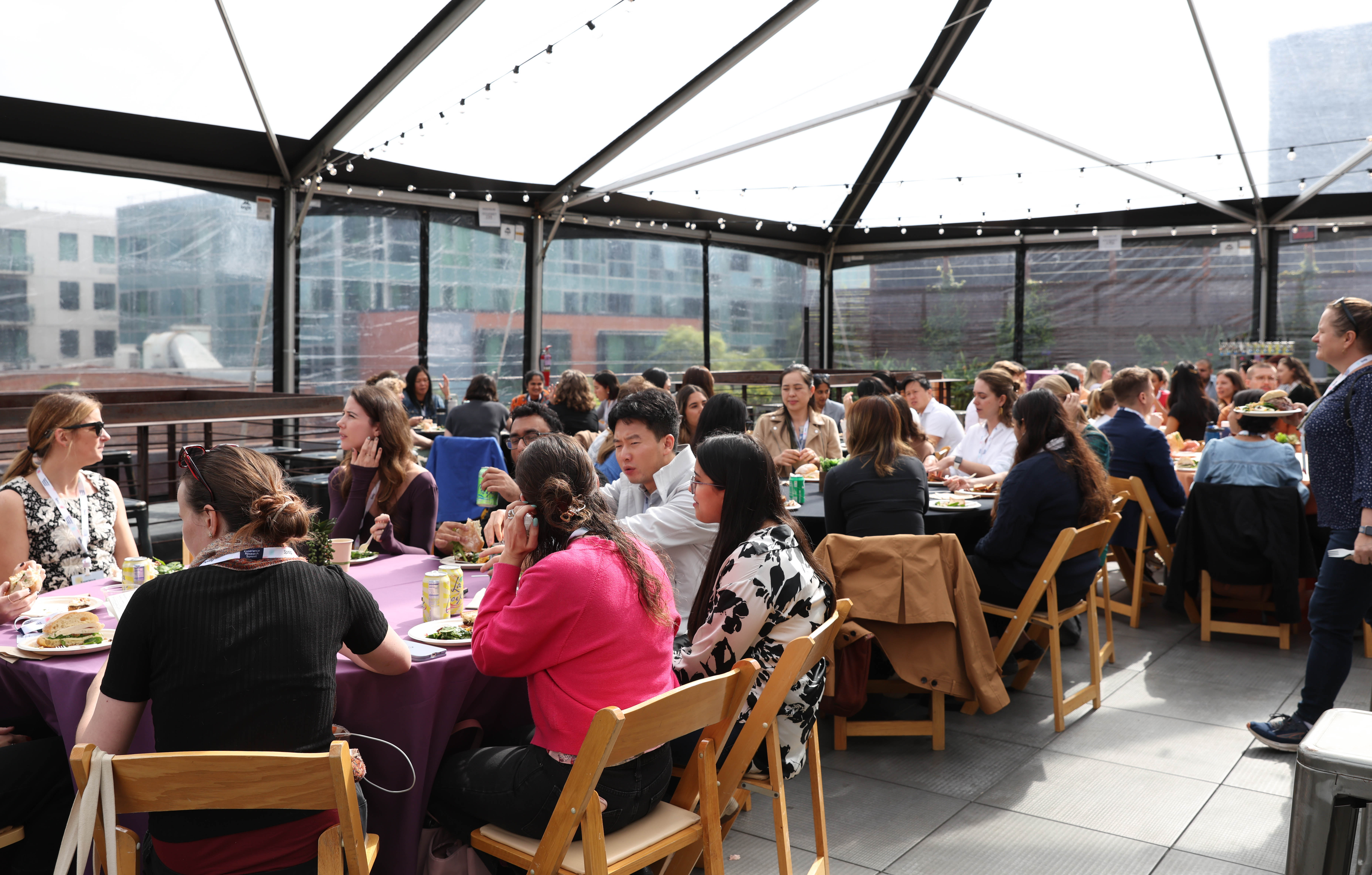 Wide shot of attendees at the Experience Research Summit in San Francisco Networking at rooftop event