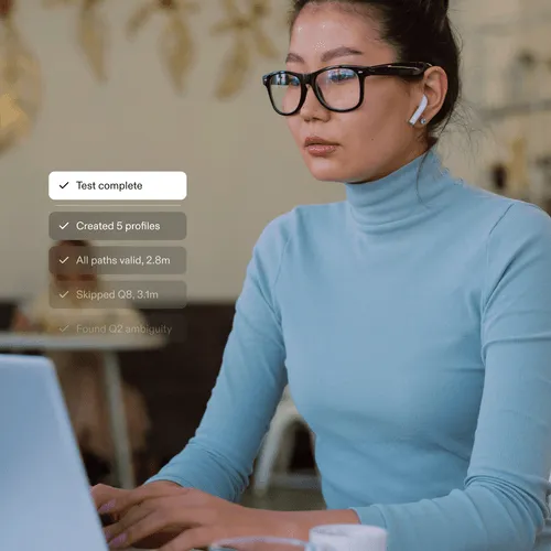 Young woman wearing glasses and blue turtleneck working on a laptop with checklist overlay showing task progress.
