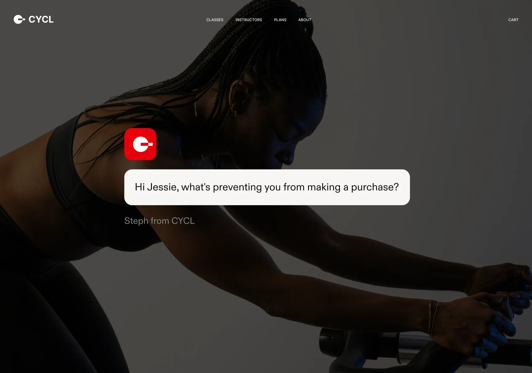 Woman with braided hair in a black sports bra and leggings leaning forward on a stationary bike, accompanied by a chat bubble asking, 'Hi Jessie, what's preventing you from making a purchase?'