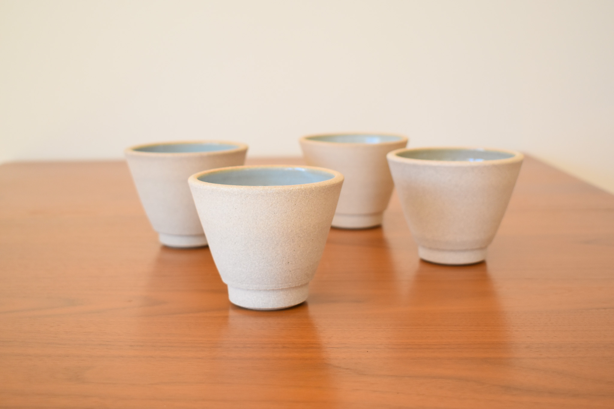 Glazed stoneware. Measures 4" wide x 3.25" tall, holding approximately 8-10oz. U can put any bev in these, hot or cold!