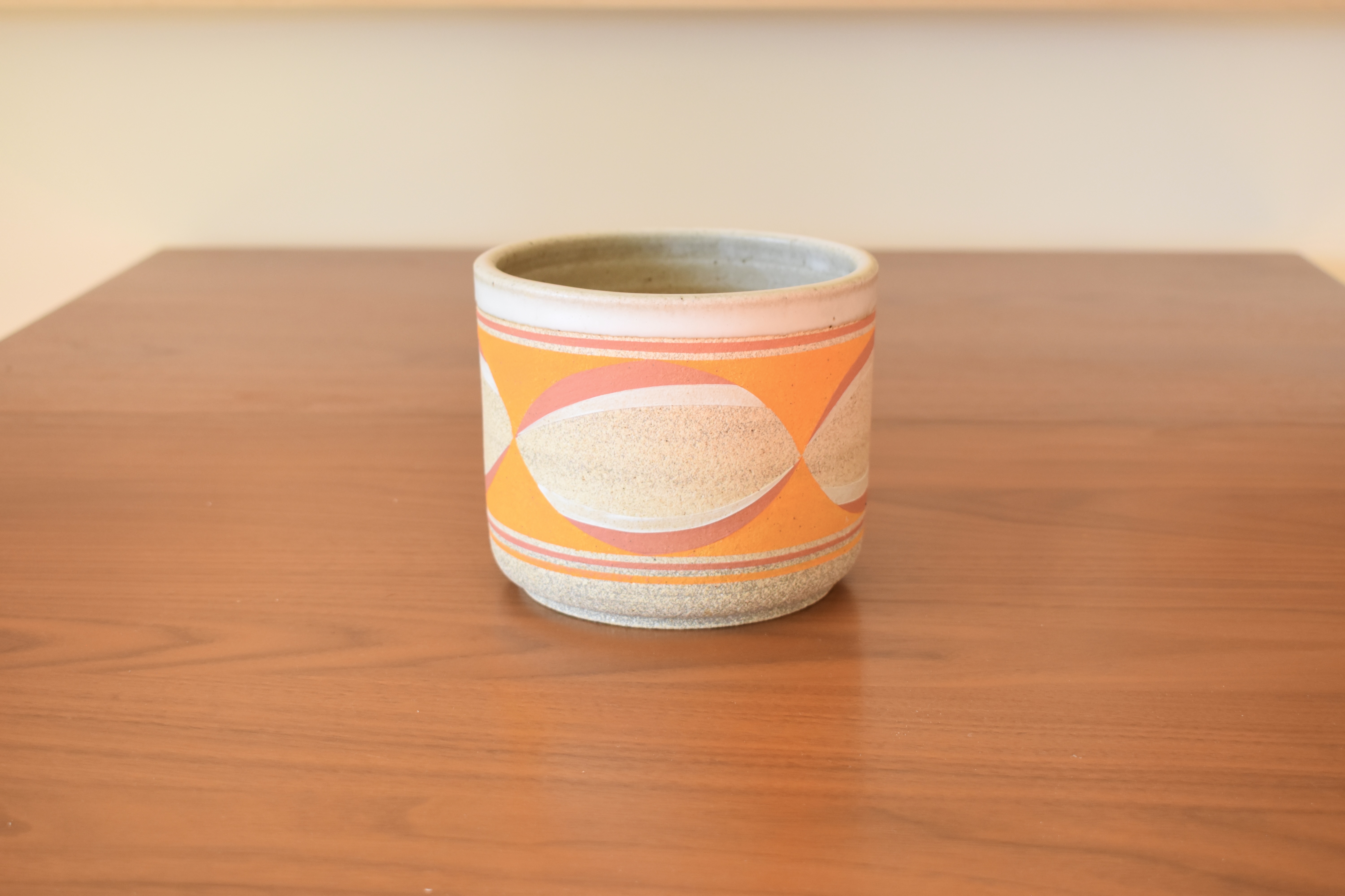 Wheelthrown with stoneware and hand painted using non toxic underglazes, and a matte white glaze. Has drainage holes. 5.5" wide x 4.75" tall