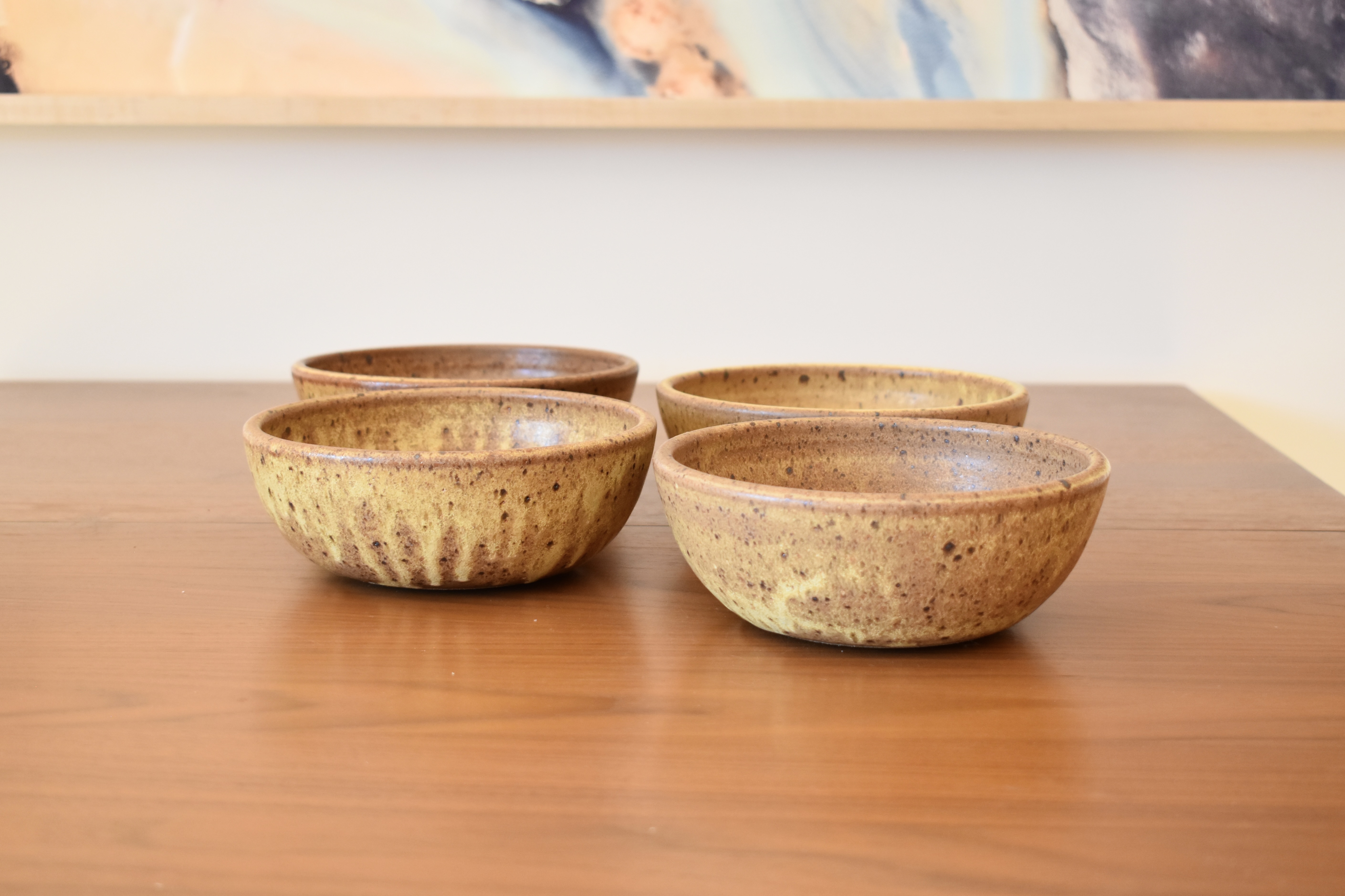 Wheelthrown using stoneware, and glazed with a dynamic yellow overripe banana-like glaze. Each bowl measures 6.75" wide x 2.5" tall.