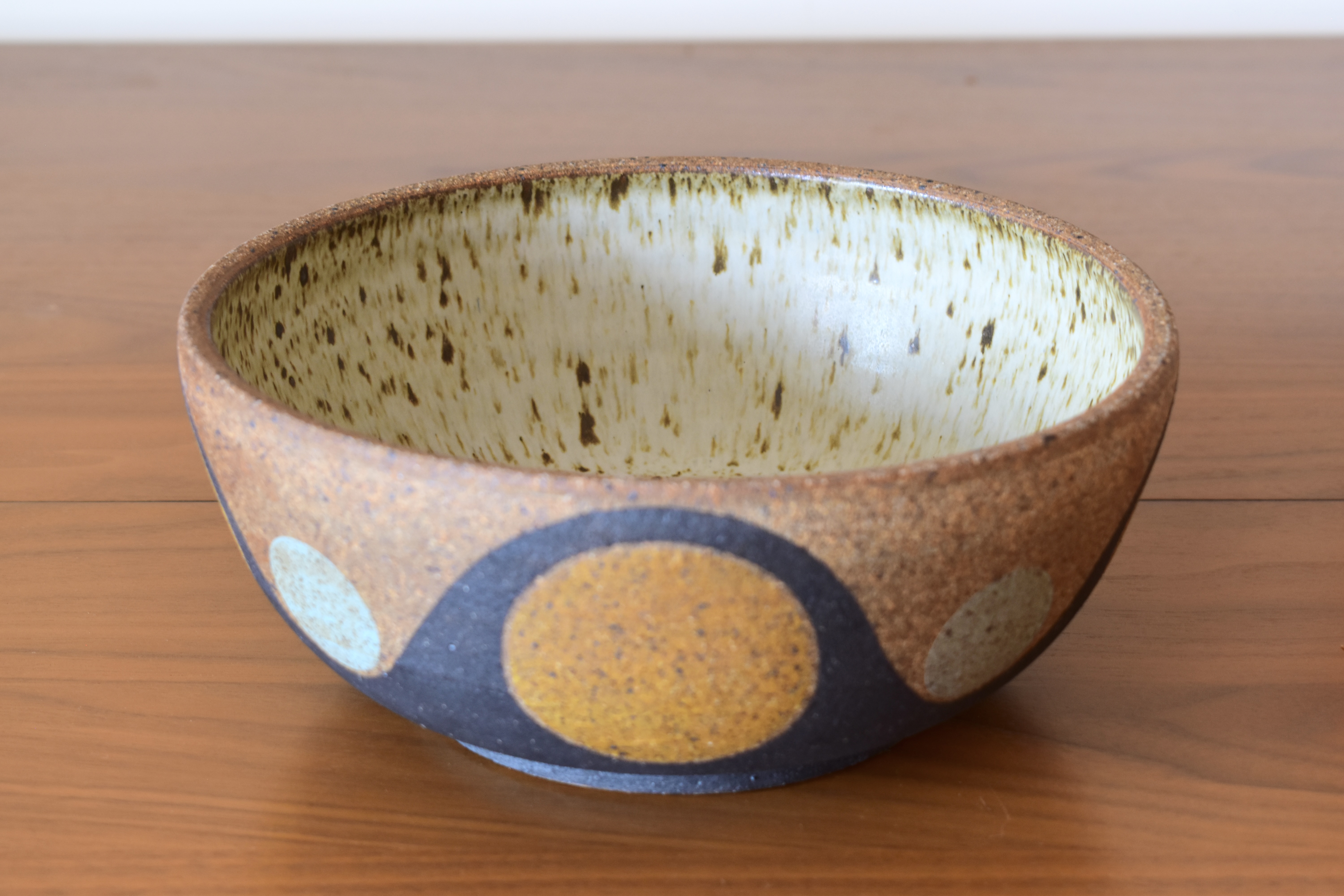 Wheelthrown with stoneware and hand painted using non-toxic underglazes and a white matte glaze. Measures 9" wide x 3.75" tall.