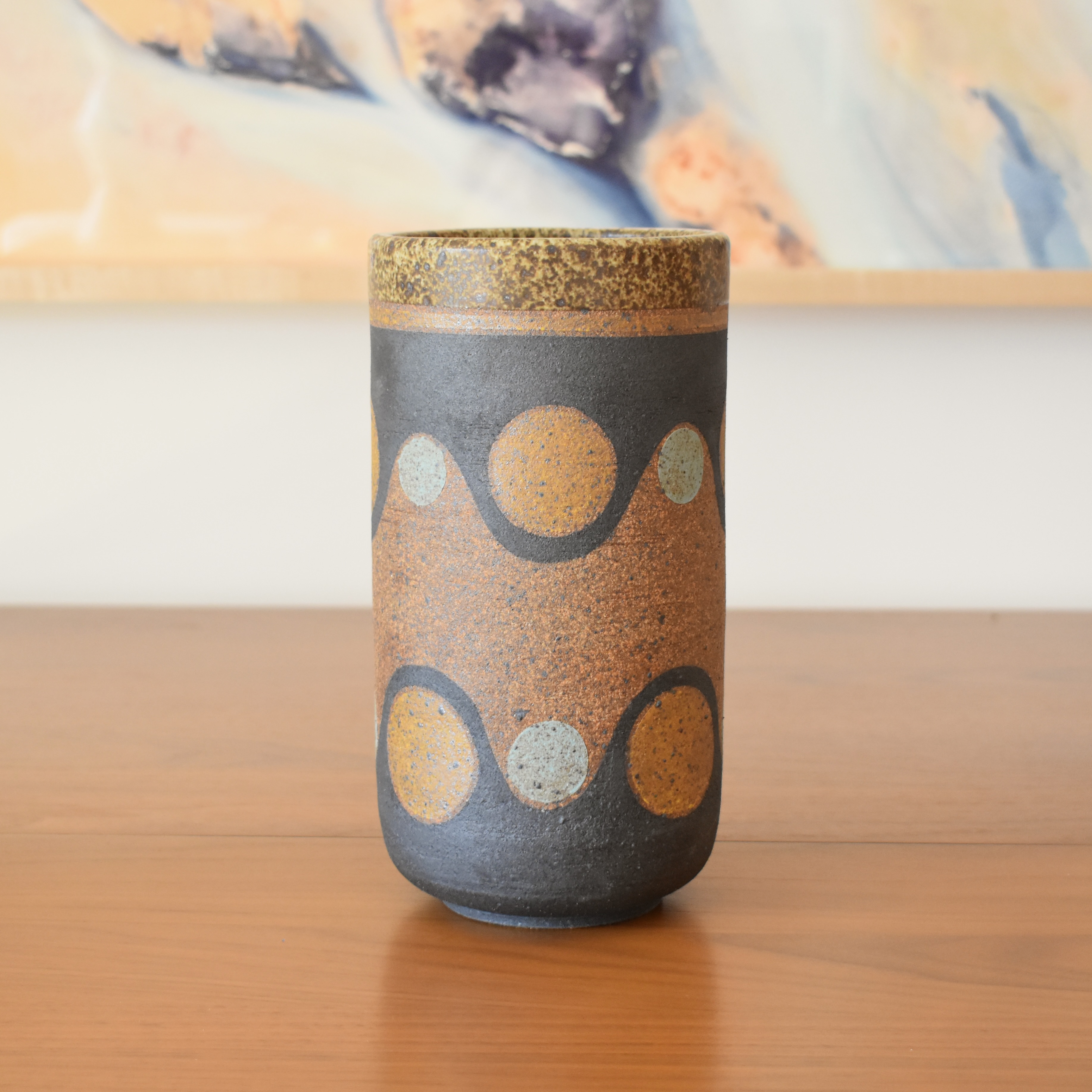 Wheelthrown with stoneware and painted with non-toxic underglazes. Outer lip and interior glazed in a heavily freckled matte white/brown glaze. 8.5" tall x 4.5" wide.
