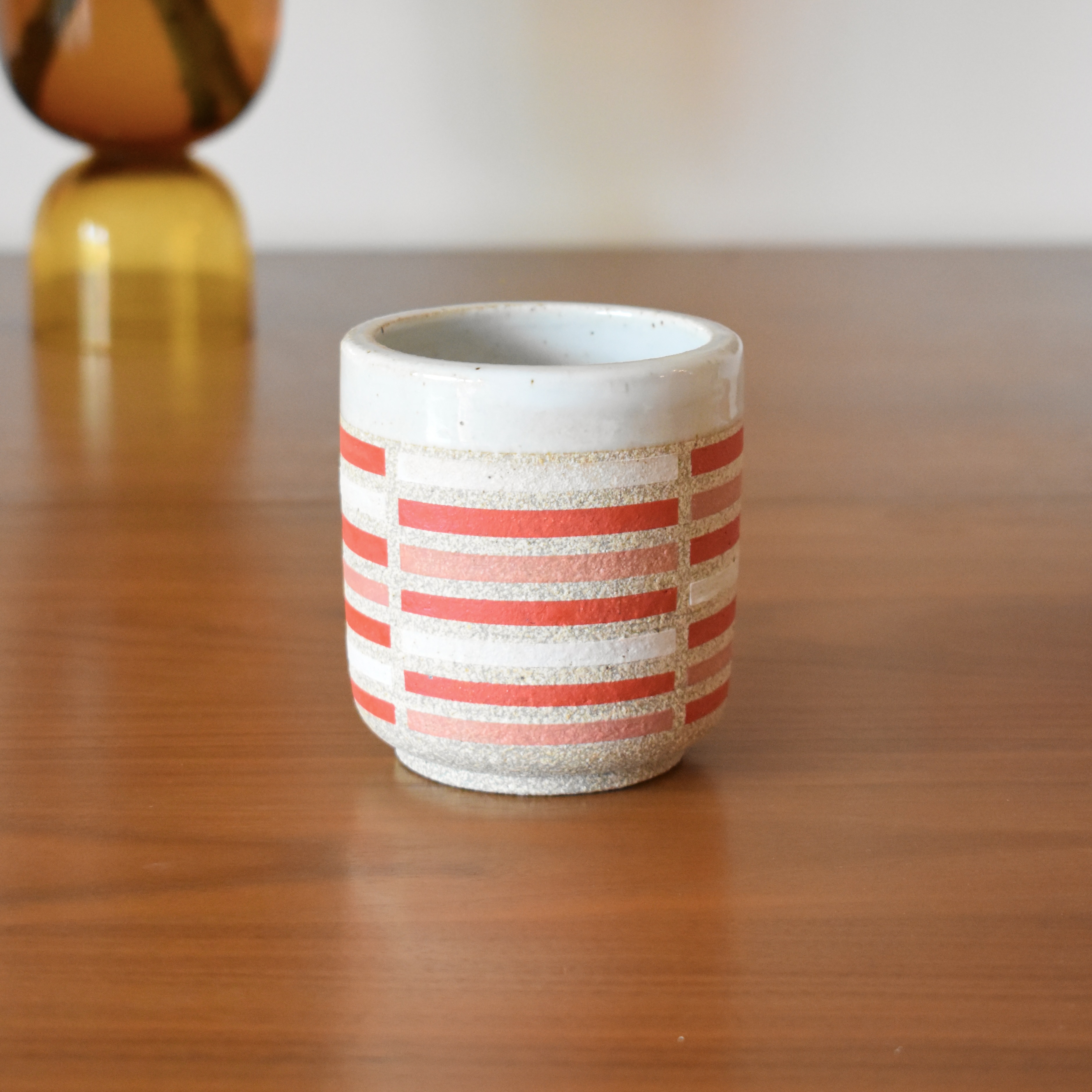 Wheelthrown with stoneware and hand painted using non-toxic underglazed. Glazed glossy white on the interior and outer lip. 3.5" wide x 3.75" tall. Holds ~10fl. oz.