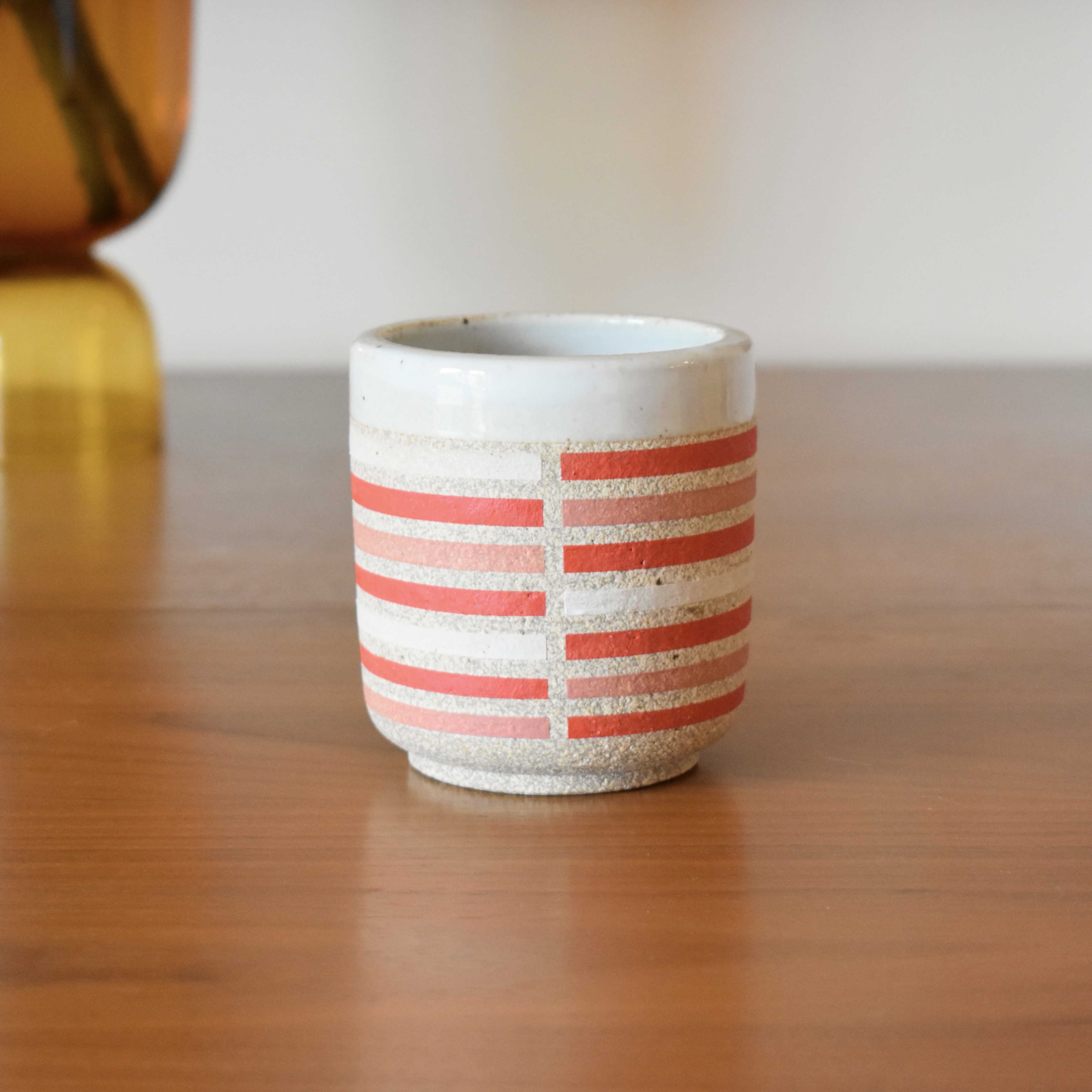 Wheelthrown with stoneware and hand painted using non-toxic underglazed. Glazed glossy white on the interior and outer lip. 3.5" wide x 3.75" tall. Holds ~10fl. oz.