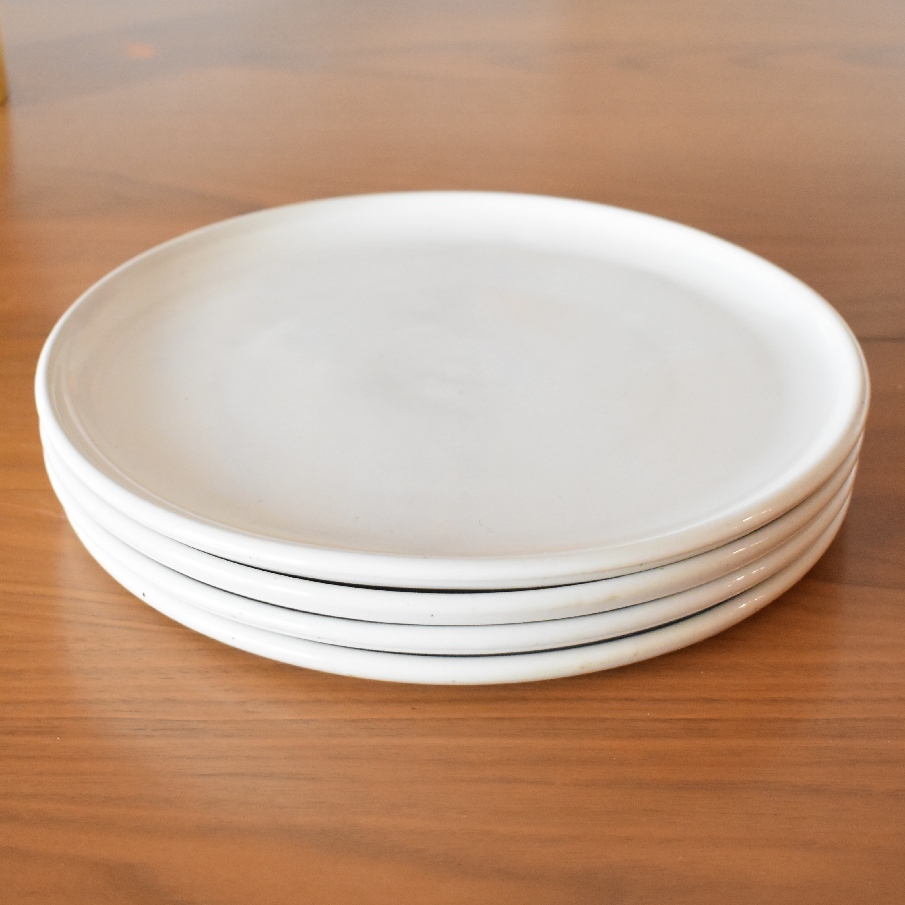Wheelthrown with porcelain. ~10" diameter. Sold as a set of four.