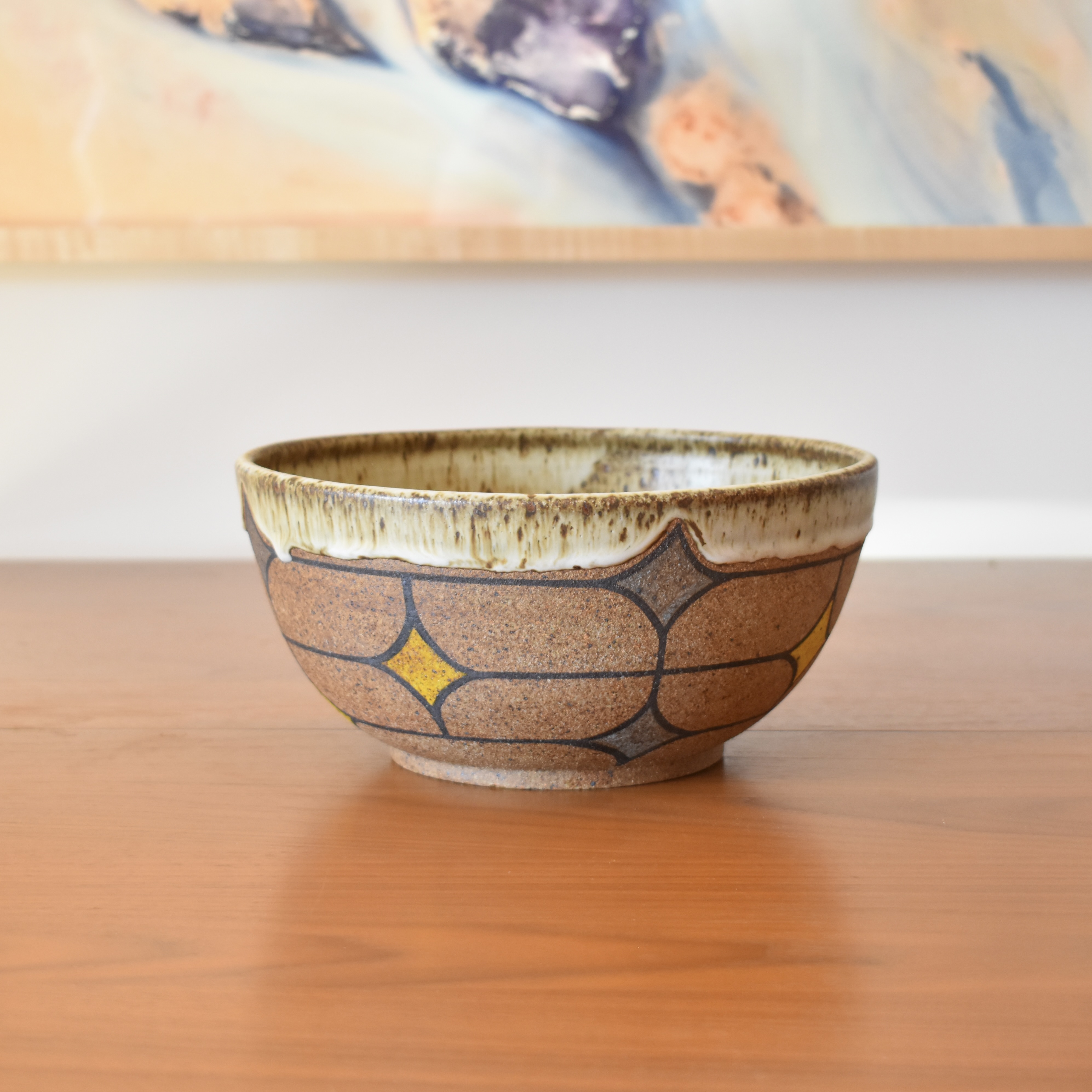 Wheelthrown with stoneware. Hand painted with non-toxic underglazes. Glazed in a speckled matte cream glaze. 9.25" wide x 4.5" tall.