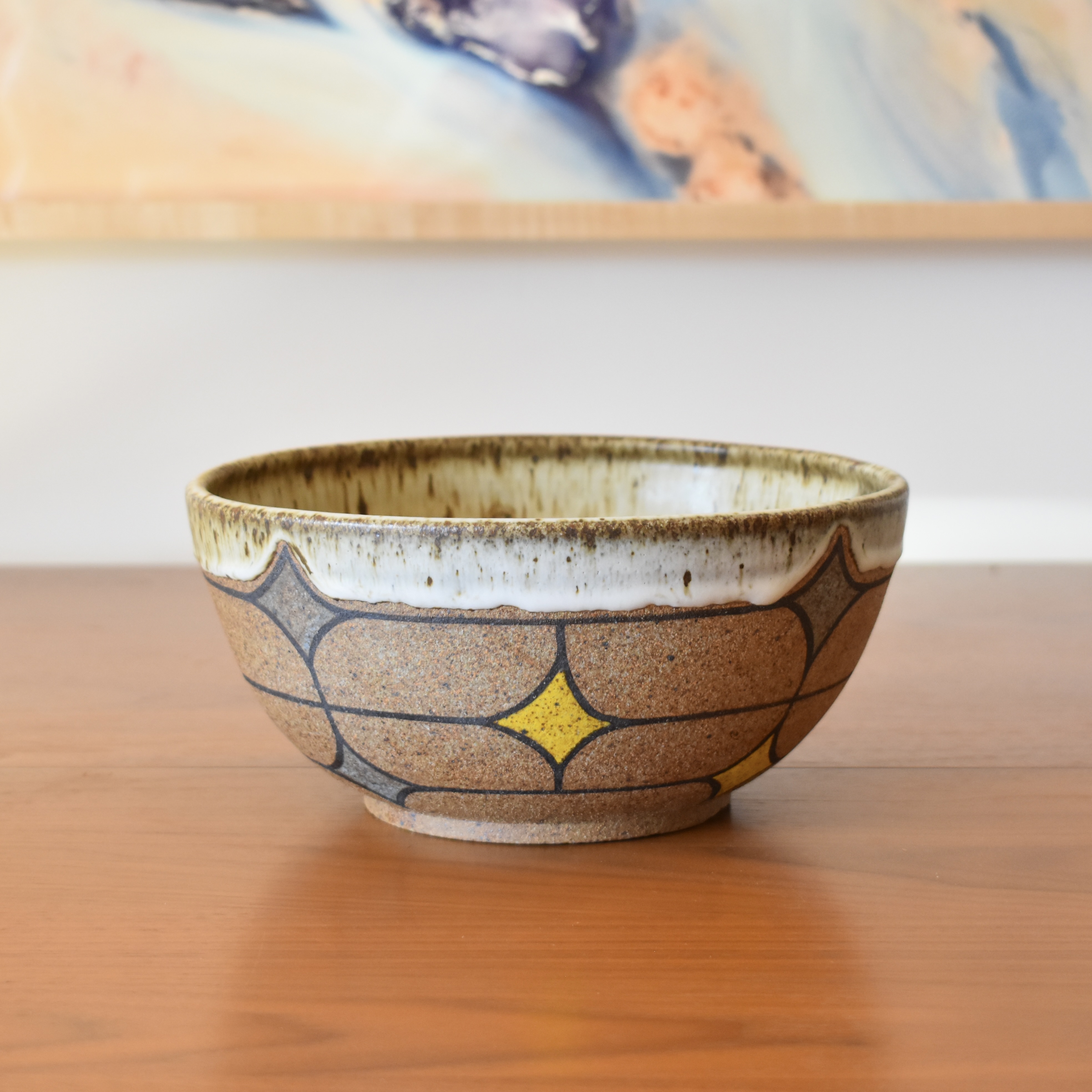 Wheelthrown with stoneware. Hand painted with non-toxic underglazes. Glazed in a speckled matte cream glaze. 9.25" wide x 4.5" tall.