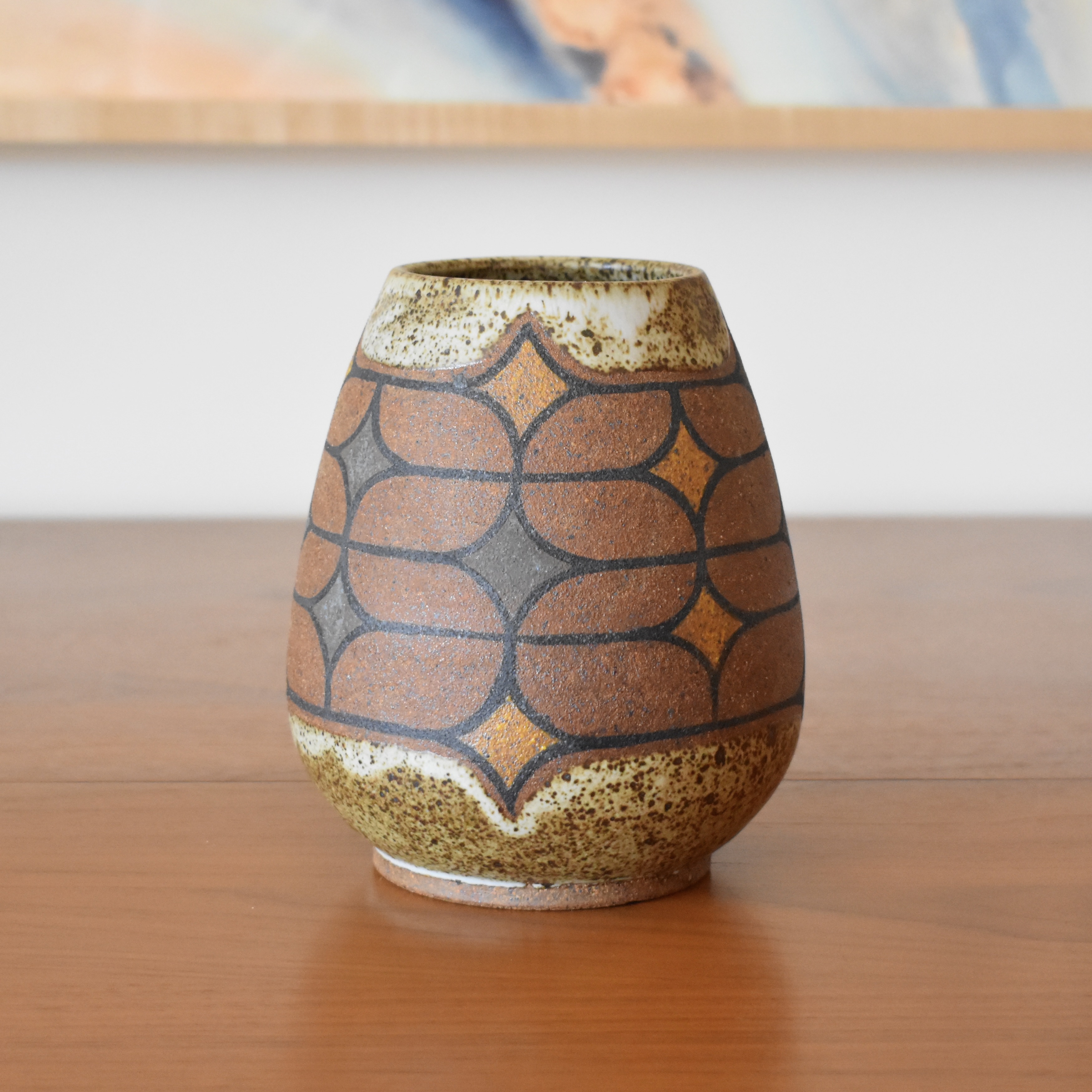 Wheelthrown with stoneware and handpainted with non-toxic underglazes. Interior and outer lip glazed in a matte, heavily freckled white glaze. Measures 6.25" tall. 