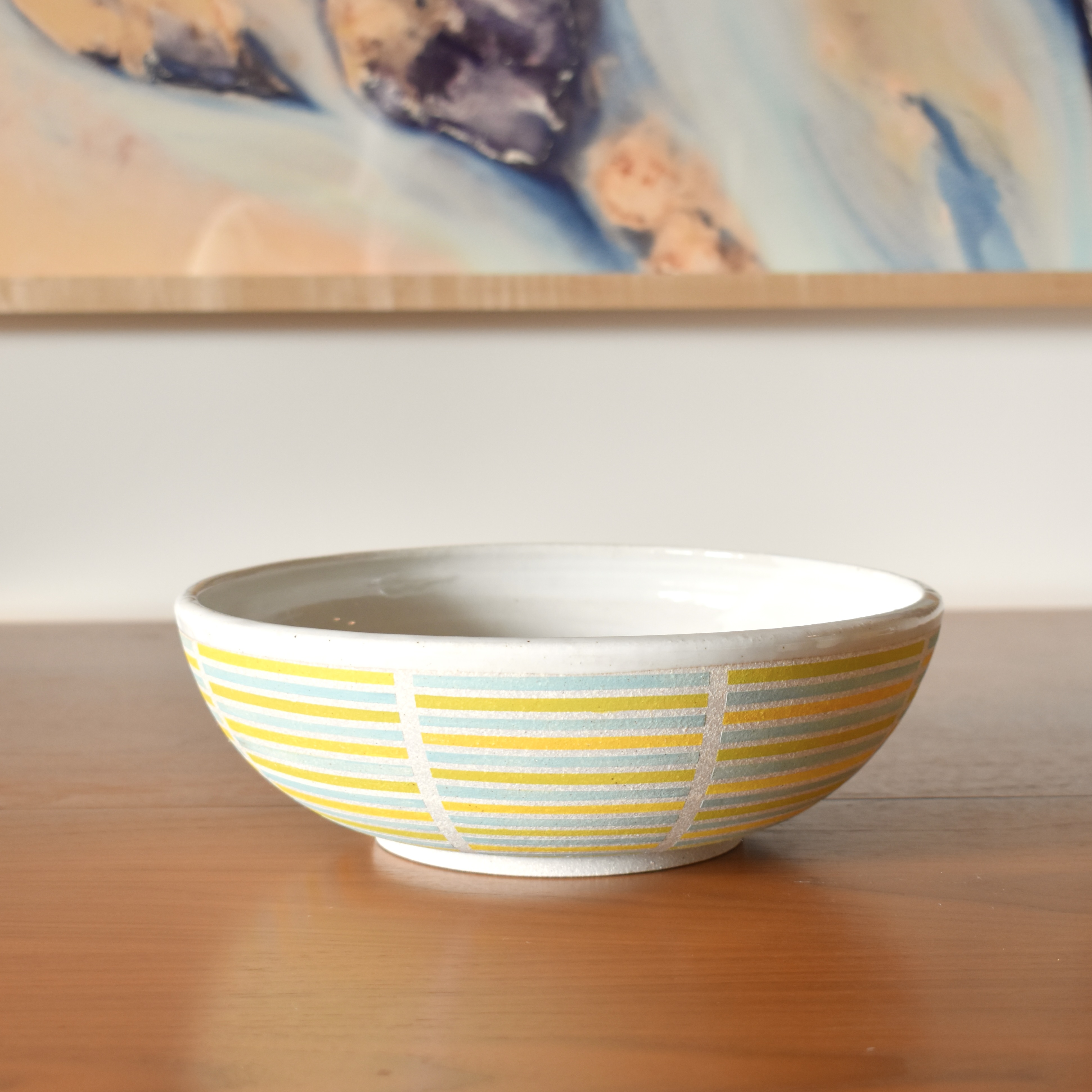 Wheelthrown with stoneware. Hand painted with non-toxic underglazes. Interior & rim glazed in a glossy white glaze. 10" wide x 3.25" tall.