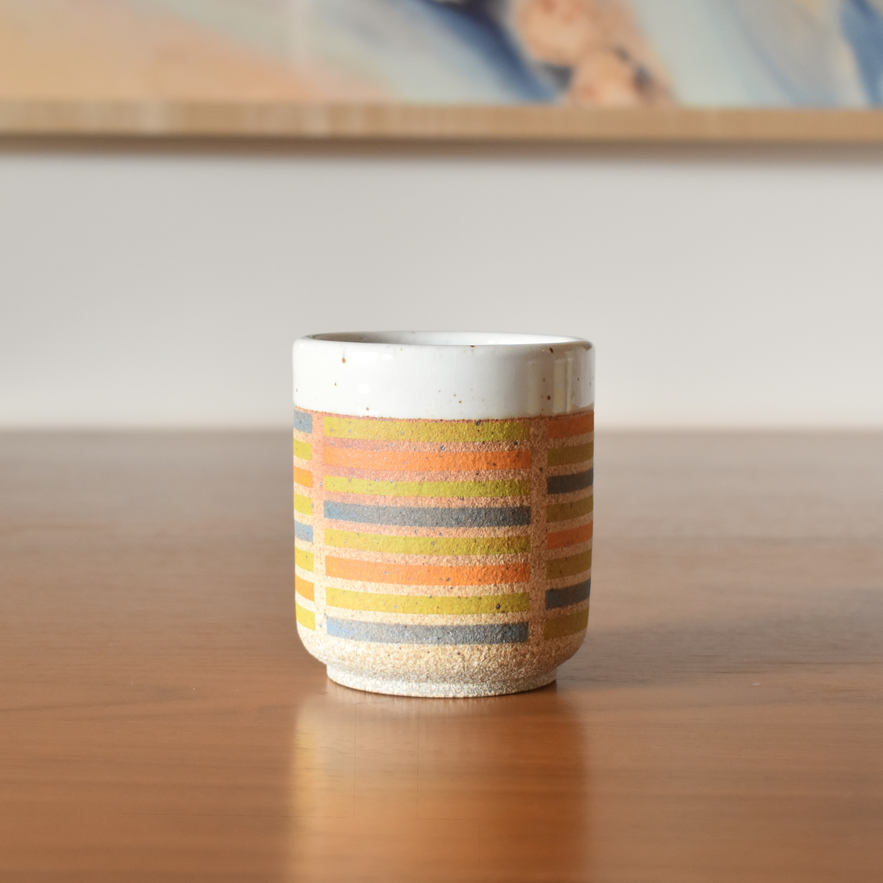 Wheelthrown with stoneware and hand painted using non-toxic underglazed. Glazed glossy white on the interior and outer lip. 3.25" wide x 3.75" tall. Holds ~10fl. oz.