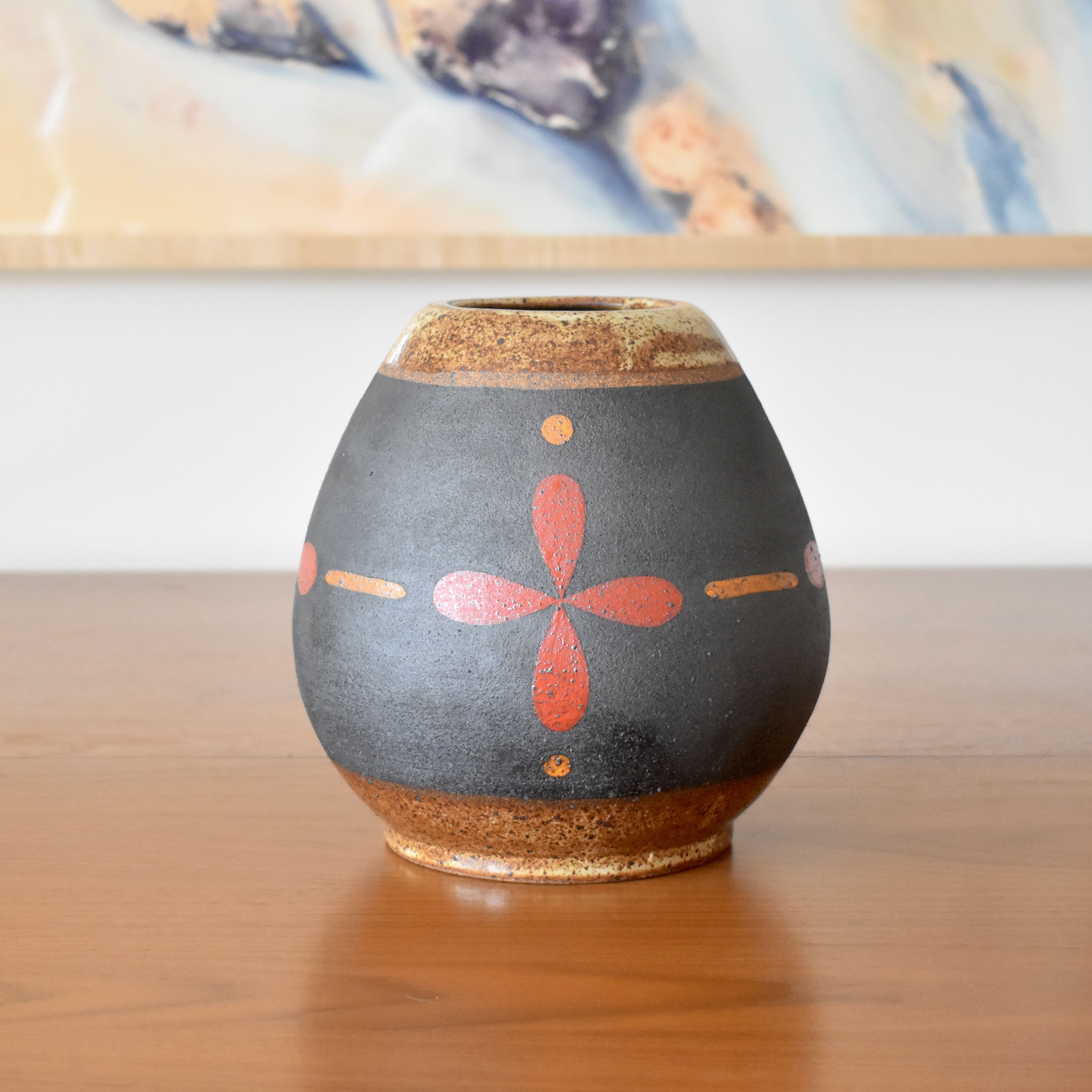 Wheelthrown with stoneware and painted with non-toxic underglazes. Outer lip and interior glazed in a heavily freckled glossy white/brown glaze. 7.5" tall, 3" opening, and overall width of 6.5". 